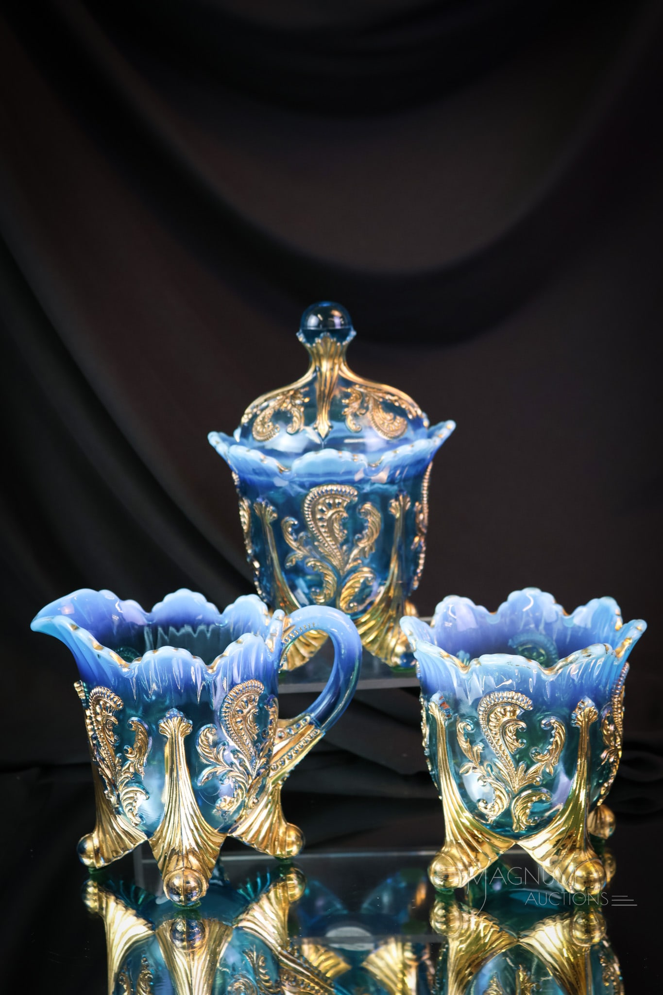3 pc Lot Northwood Blue Opalescent Glass Inverted Fan & Feather: Three pieces of the table set in the Northwood Inverted Fan and Feather pattern. This lot offers a covered sugar, a creamer, and a spooner. The tallest measures 7". SHIPPING NOTICE: If you choose not 