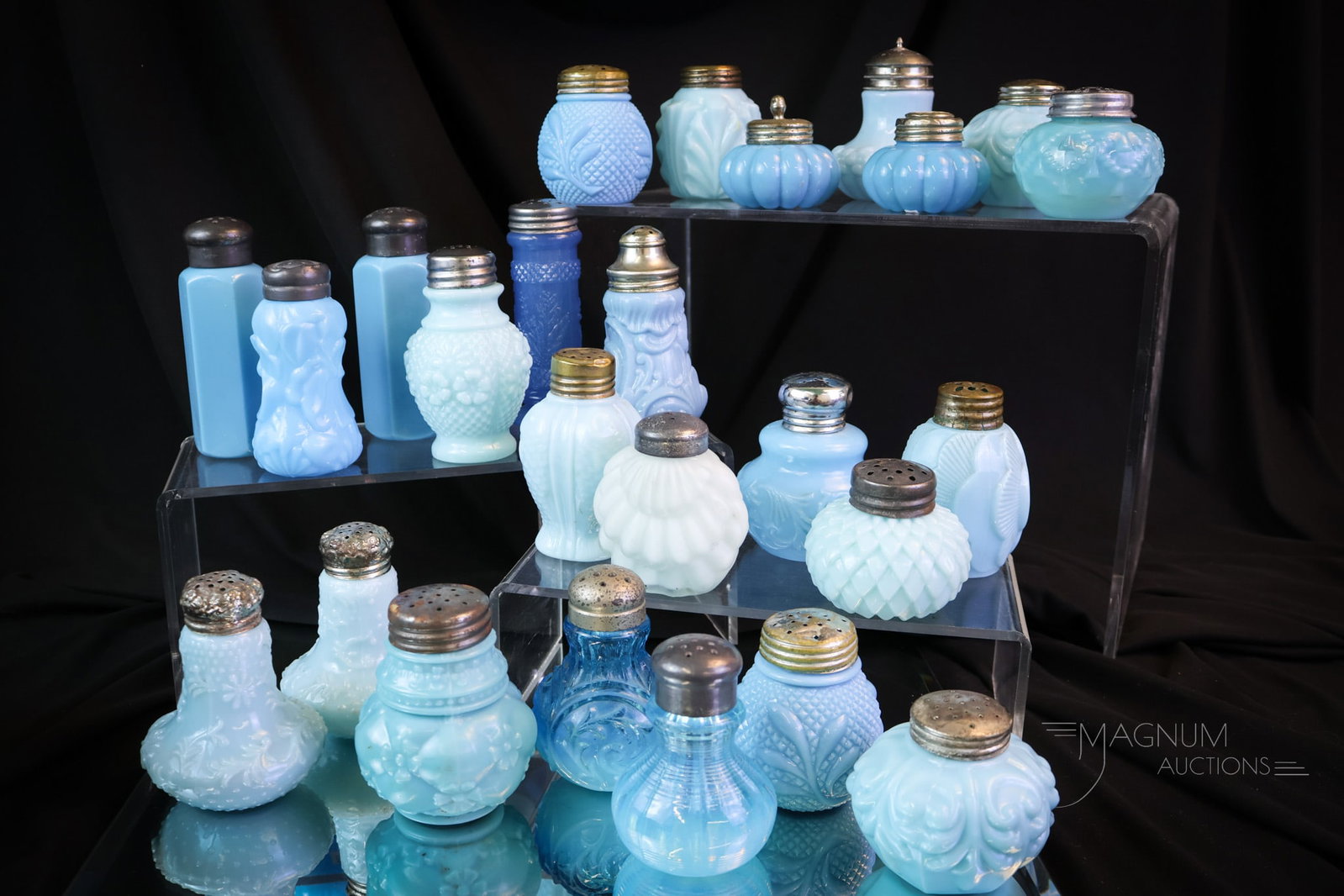 25 pc Lot Victorian Blue Glass Salt Shakers: The possibilities are endless with this array of blue themed Victorian glass salt shakers. This lot includes five matched pairs of shakers. Makers such as Northwood, Consolidated, and more are represe