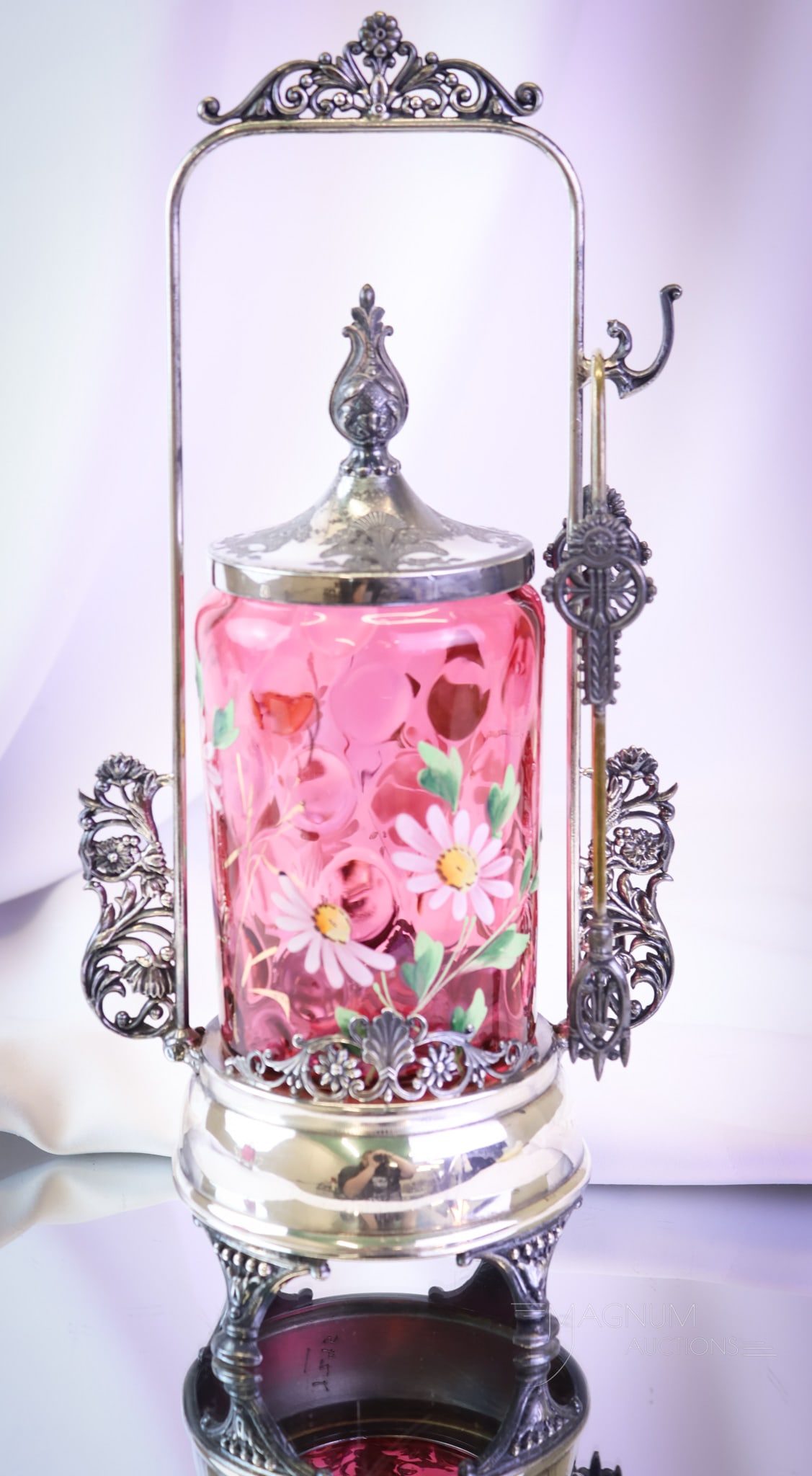 Cranberry Enameled Victorian Silverplate Pickle Castor: A fine Victorian piece for your table. This is a silverplate pickle castor. It embraces a cranberry enameled floral decorated jar. This castor measures 13" tall. SHIPPING NOTICE: If you choose not to