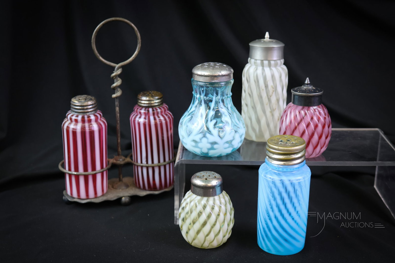 7 pc Lot Opalescent Victorian Glass Salt Shakers Cranberry Blue Vaseline: A seven piece lot of Victorian cranberry blue and vaselione glass salt shakers. This lot includes a piar of cranberry opalescent stripe in a silverplate holder. The tallest measures 7 1/2". Patterns i