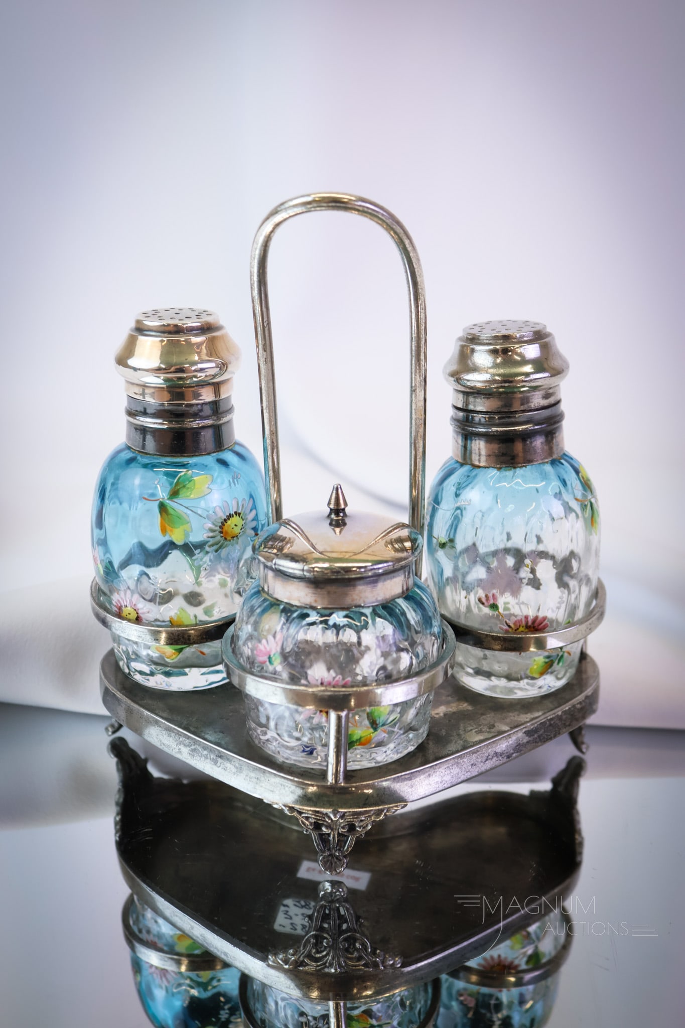 Meriden Silverplate Bluerina Glass Victorian Shaker Condiment Set: A beautiful set of Victorian enameled bluerina glass shakers and a mustard jar in a signed Meriden silverplate holder. This super offering is complete and has great color, enameling, and holder. It wi