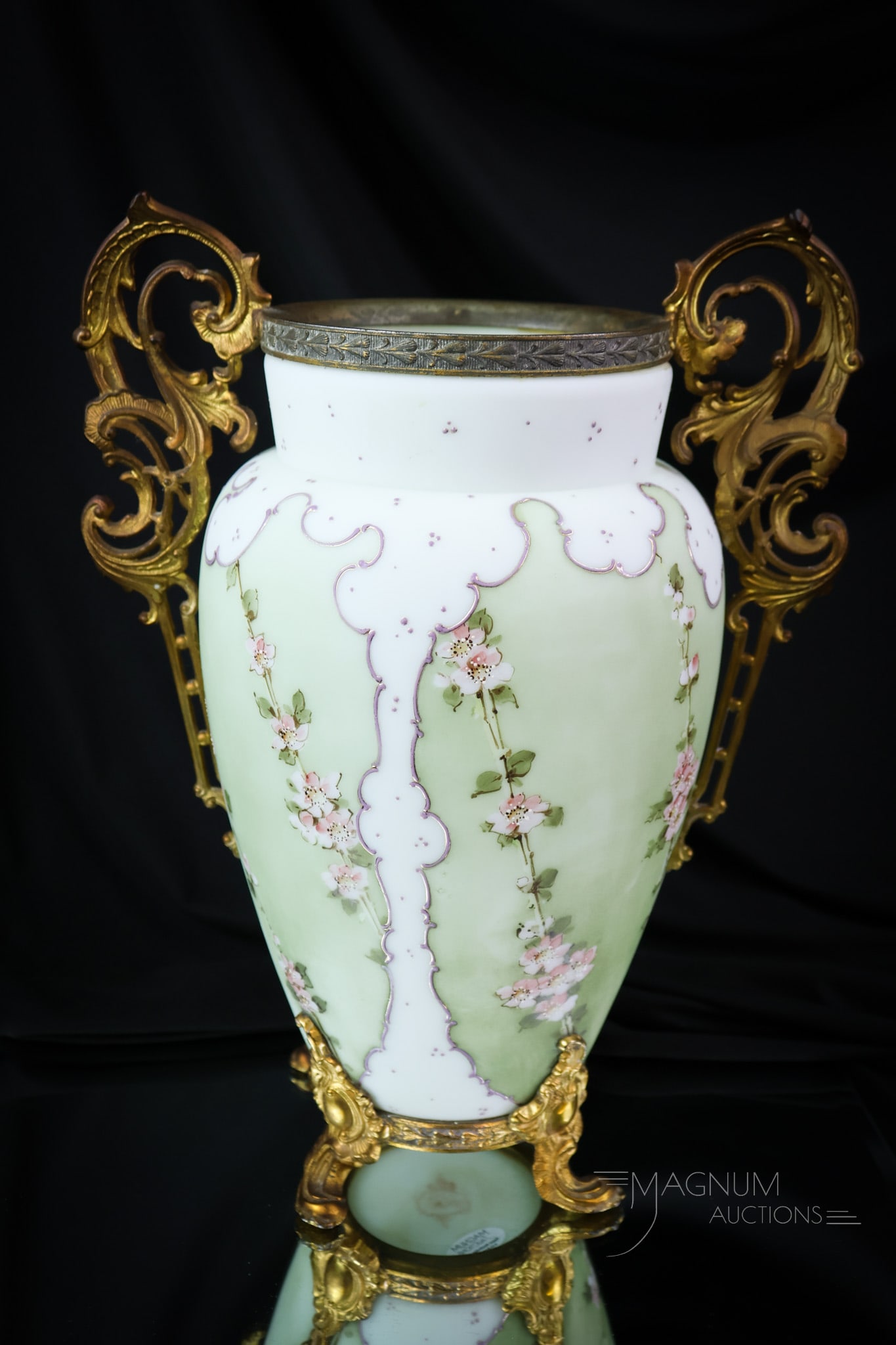 Signed Wavecrest 12 1/2" Ormulu Victorian Glass Mantle Vase: A quinticentually Victorian piece of wavecrest art glass. This piece is signed and the body features sage green panels adorned with pink flowers. It is further enhanced by gilt ormulu handles. The vas