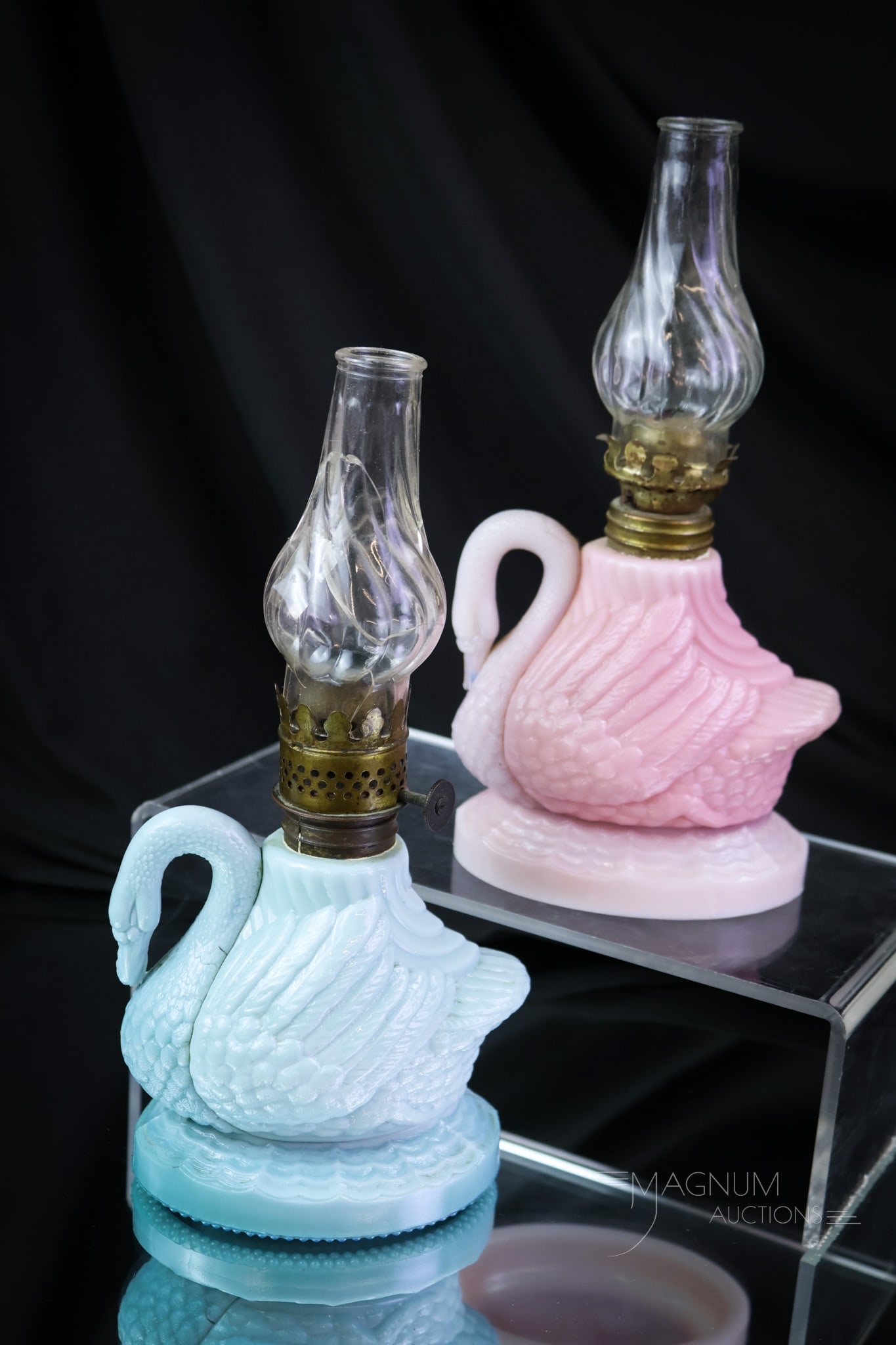 2 pc Lot Atterbury Swan Victorian Miniature Oil Lamp Bases: Two Atterbury Swan Victorian glass miniature oil lamps. One in pink and one in blue. Elegant forms from a by-gone era. Each measures 4" tall. SHIPPING NOTICE: If you choose not to utilize the LiveAuct