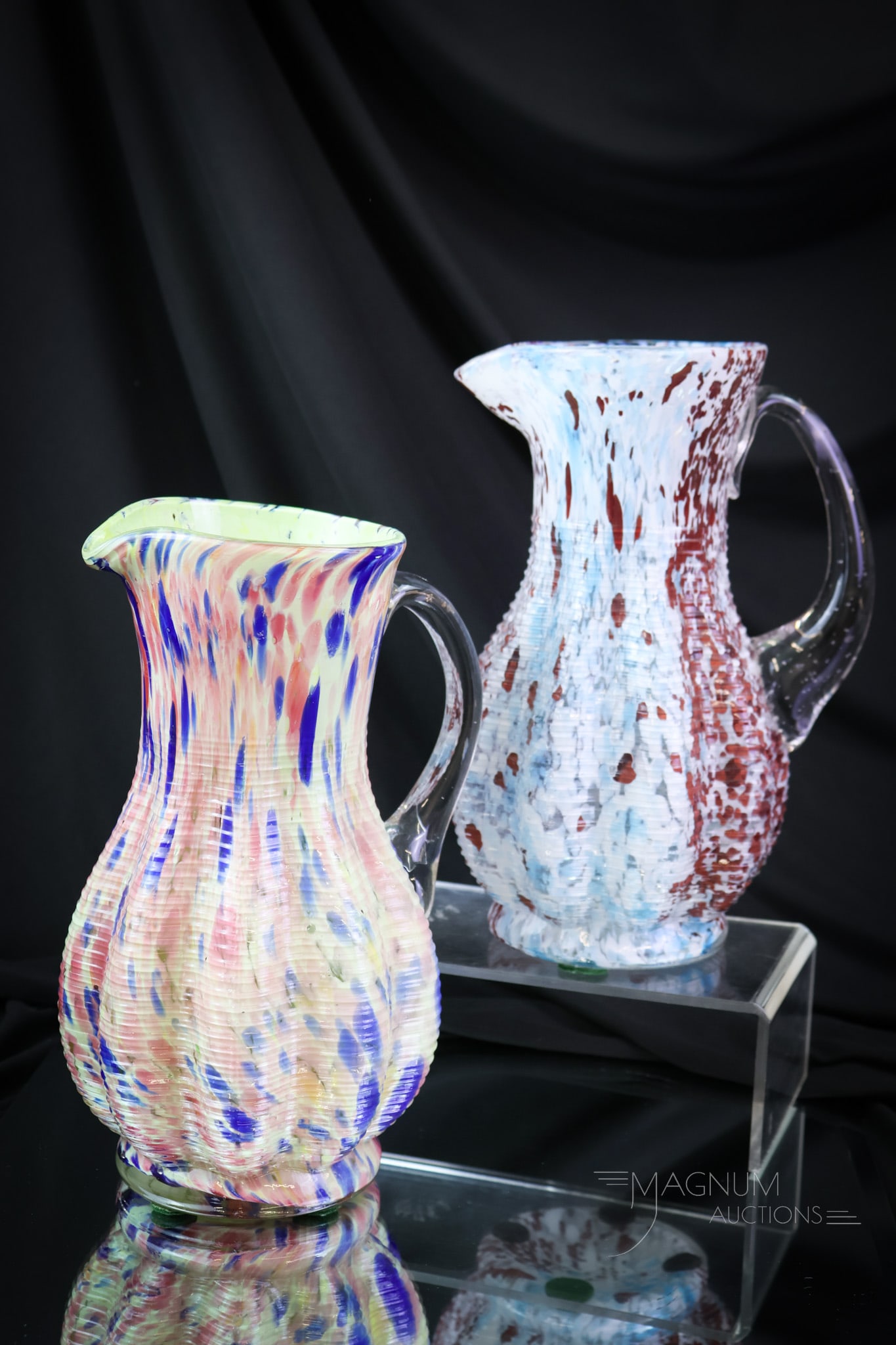 2 pc Lot French Legras Victorian Spatter Art Glass Pitchers: Two desirable finds in French Legras art glass pitchers. Both of these are in spatter glass. One of the pitchers is horizontally ribbed for pleasure and cased. The other is custard-like with multi-col