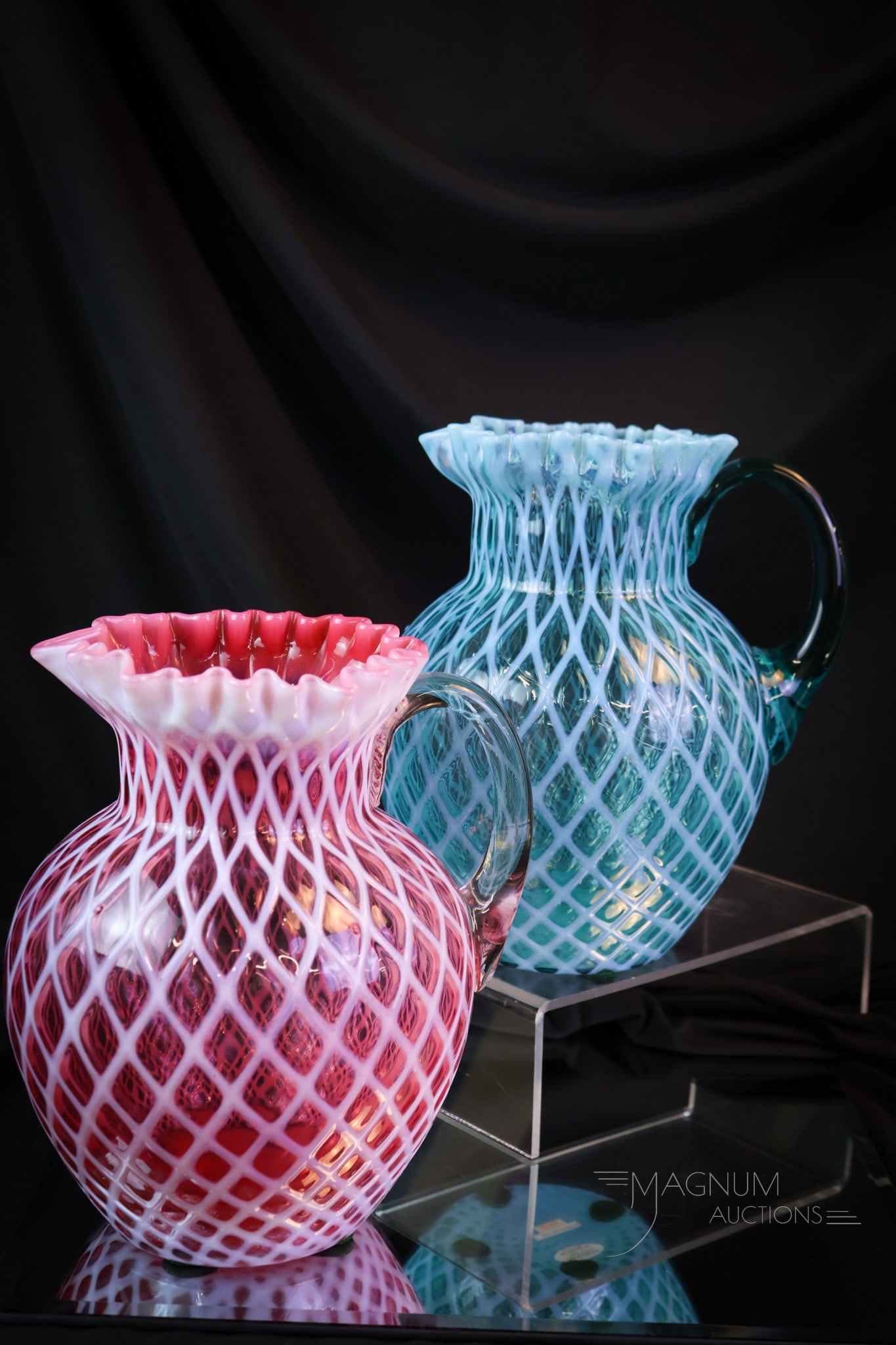 2 pc Lot Northwood Lattice Victorian Opalescent Water Pitchers Cranberry & Blue: Two identical water pitchers, except one is cranberry and one is blue. These beautiful pitchers were made by Northwood and in the Lattice pattern. Each measures 9" tall and 7" wide. Both have pronounc