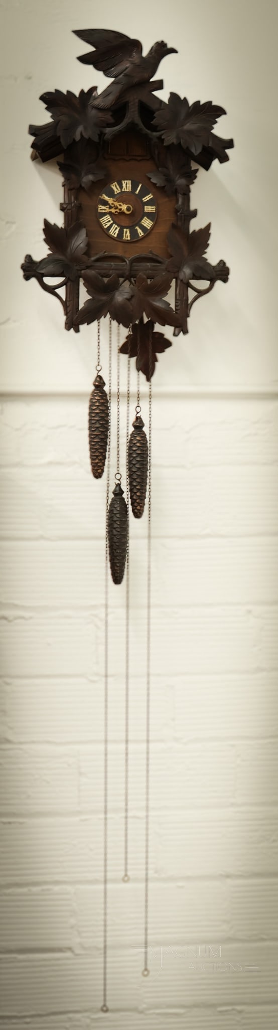 German Black Forest Carved Cuckoo Clock: A fun piece to add to your collection. This is a German Black Forest carved Cuckoo Clock. This piece appears to be in working order. There are 3 pine cone weights. The clock measures 21" by 15". SHIPP