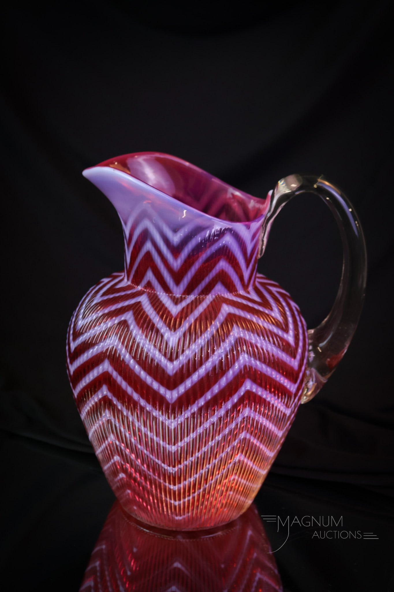 Northwood Cranberry Ribbed Herringbone Victorian Glass Water Pitcher As-Is: A beautiful cranberry opalescent Ribbed Herringbone Victorian Glass water pitcher. Alas, this piece is as-is. Still a rare find. It has a crack in the body as shown. It will sit on the shelf, and your