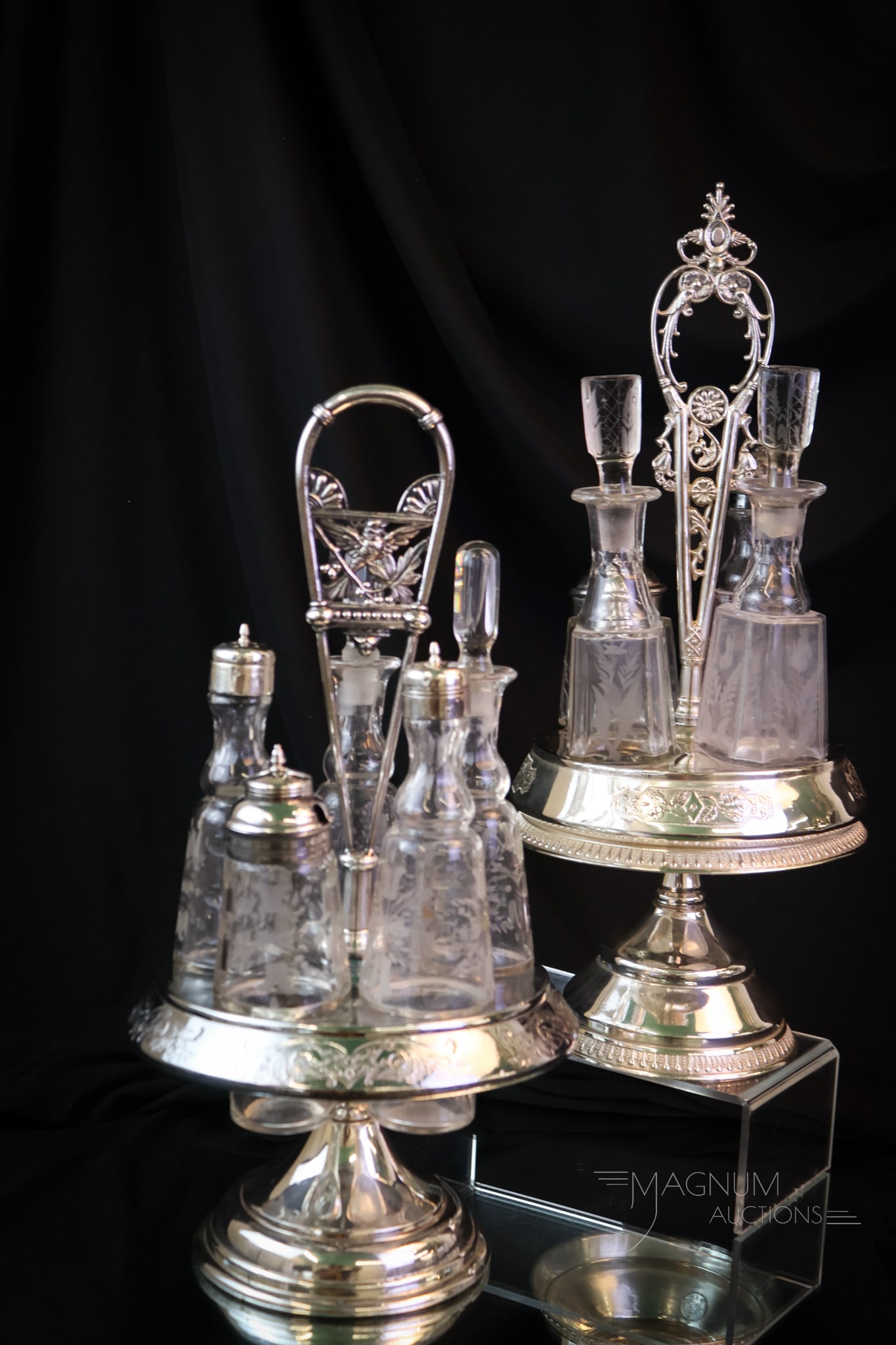 2 pc Lot Victorian Silverplate & Glass Condiment Castors: Two nice finds in Victorian condiment castors. One is a Manhattan four-bottle set. The other is a five-bottle set and is unmarked. The tallest measures 16". SHIPPING NOTICE: If you choose not to utili