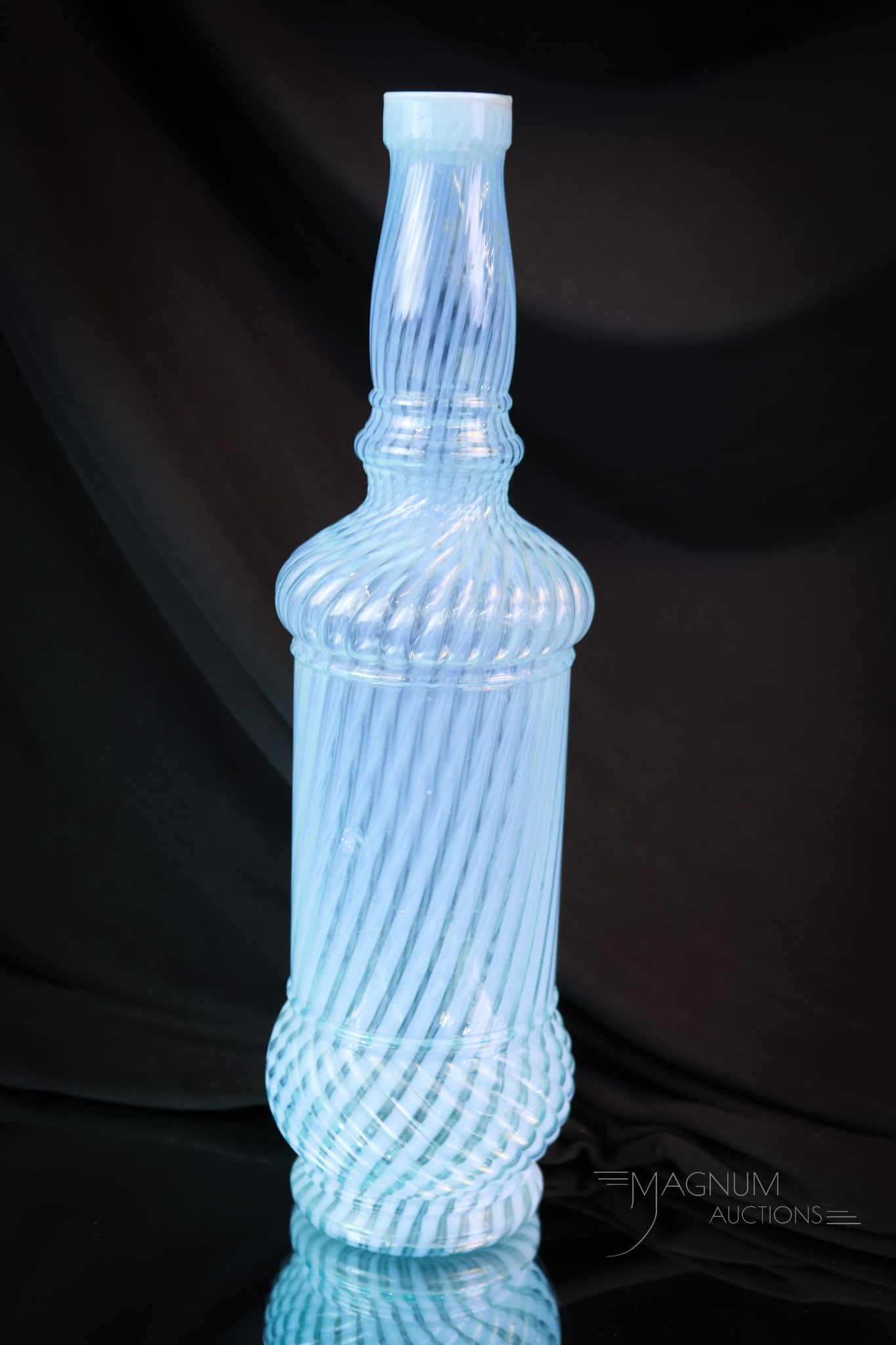 Blue Opalescent Victorian Northwood Glass Swirl Bar Bottle: A seldom-found bar bottle if you have been looking. Not many of these around, we dare say. This is a Northwood bottle in a beautiful blue opalescent Swirl pattern. This bottle measures a tall 12 1/2".