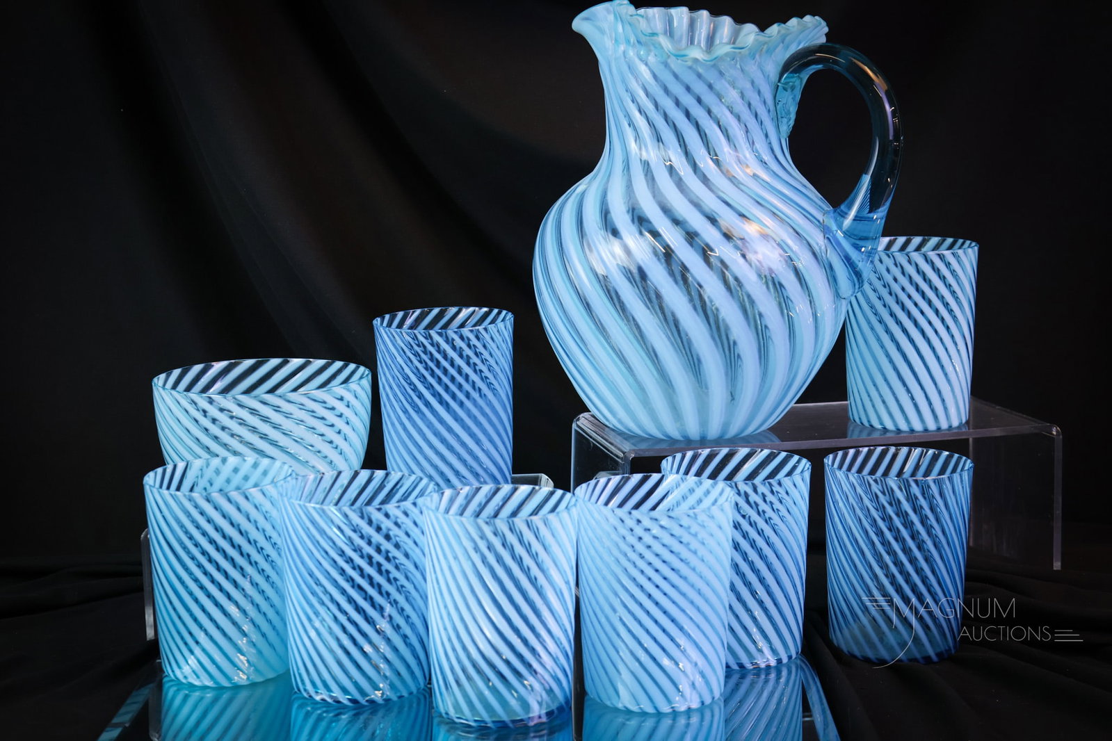 10 pc Lot Hobbs Blue Opalescent Swirl Victorian Water Set & More: A large offering of a ten-piece culmination of blue Hobbs Victorian glass in the form of a water set. This lot offers a pitcher, eight tumblers, and a bowl. Set a date for your party now. You'll need 