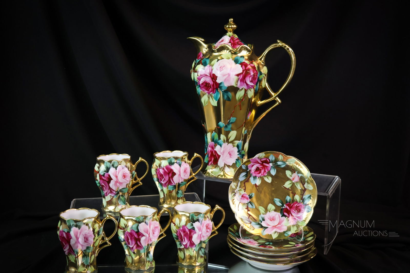 11 pc Green Mark Nippon Gold Pink & Red Roses Porcelain Chocolate Set: A showstopping find in Green Mark Nippon porcelain. This is an eleven-piece set. Each piece is beautifully adorned with pink and red roses against a gilt background. There is a chocolate pot and five
