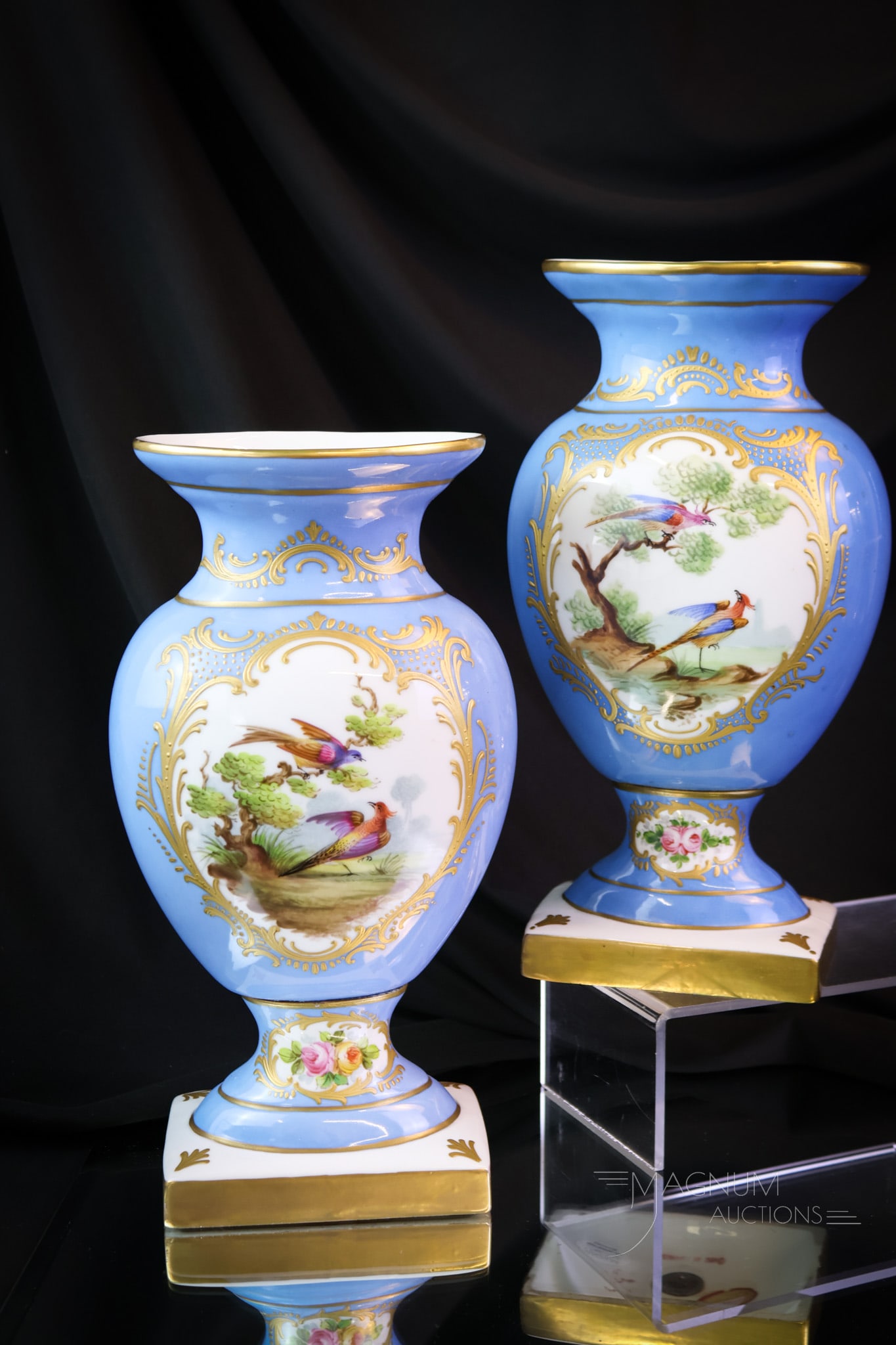 Pair of Sevres Porcelain Decorated Mantle Vases: A wonderful pair of Sevres porcelain decorated mantle vases. Each features birds and roses against a blue gilt ground. Each measures 11 1/4" tall. SHIPPING NOTICE: If you choose not to utilize the Liv