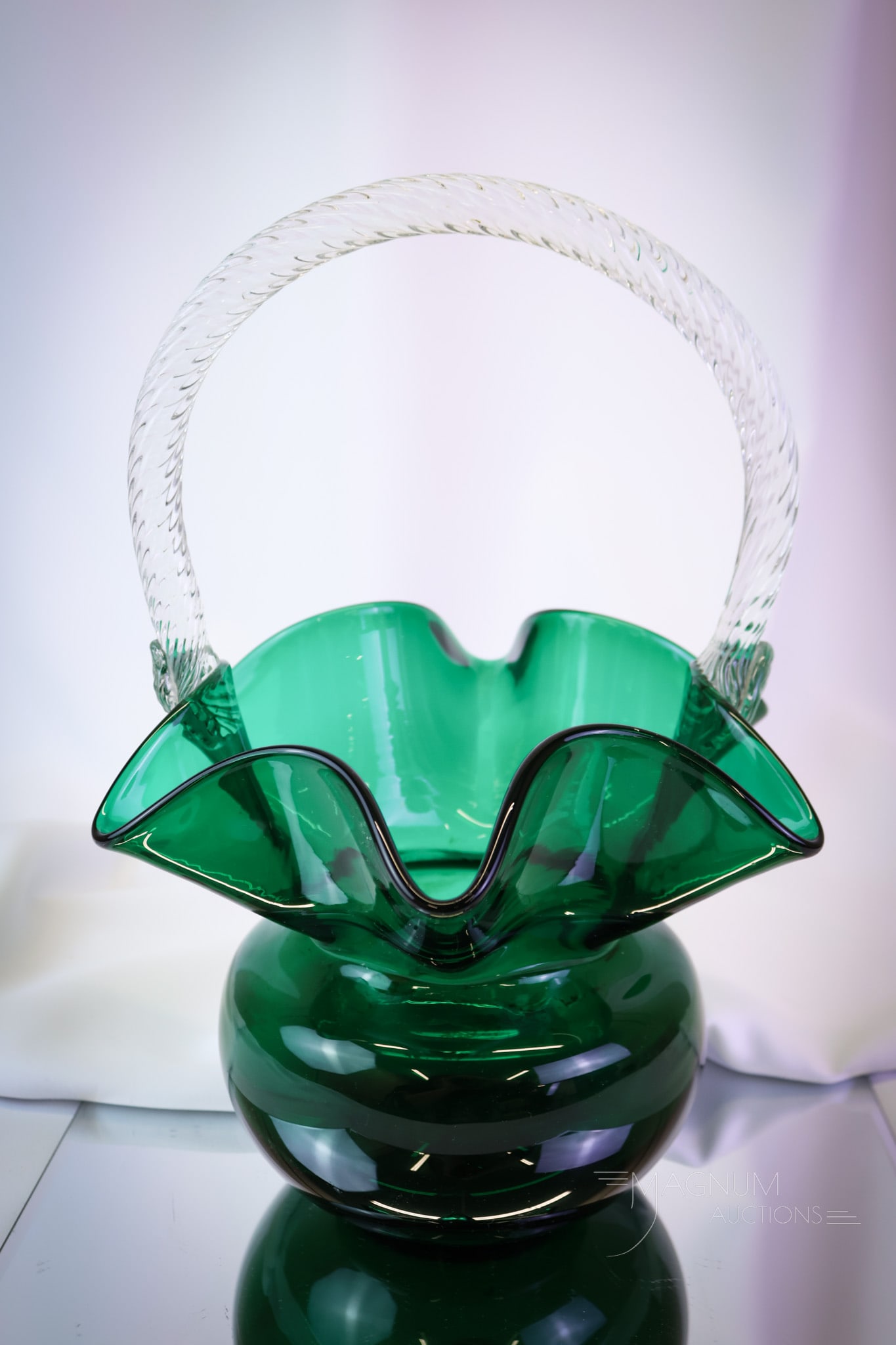 Morgantown Steigel Green Trindle Basket: A beautiful Morgantown glass Trindle basket in Steigel green coloring. This basket measures 13" tall and 9" wide. SHIPPING NOTICE: If you choose not to utilize the LiveAuctioneers LiveShip program, MA