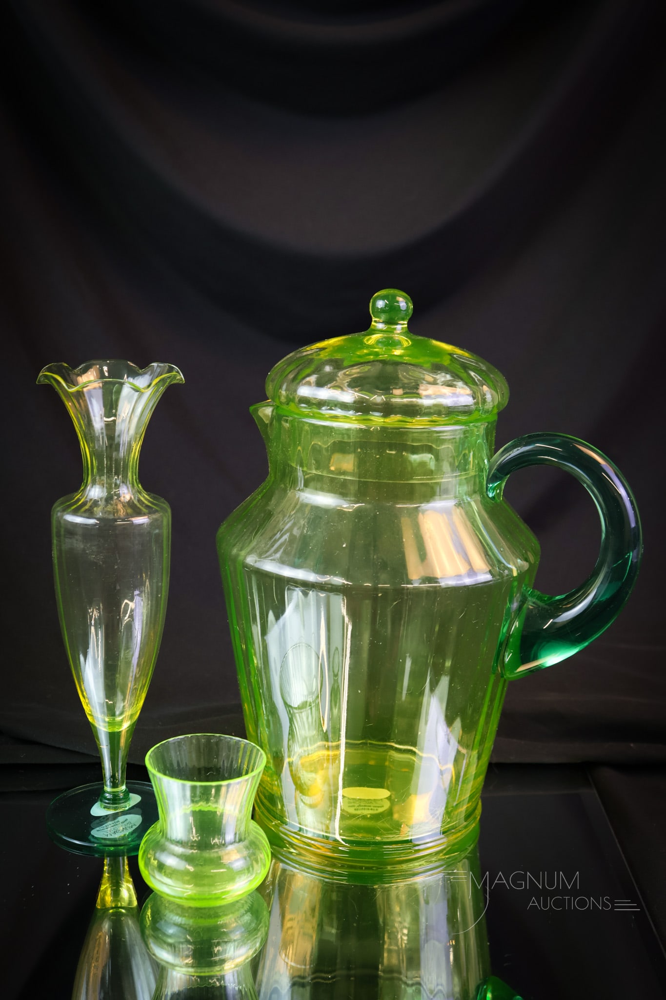 3 pc Lot Utility Glassworks & More Vaseline Uranium Glass: Three nice finds in glowing vaseline glass to make you giddy. This lot includes a lidded pitcher with a teal handle. A vase with a teal foot. The last is a vaseline glass toothpick holder with ribbing