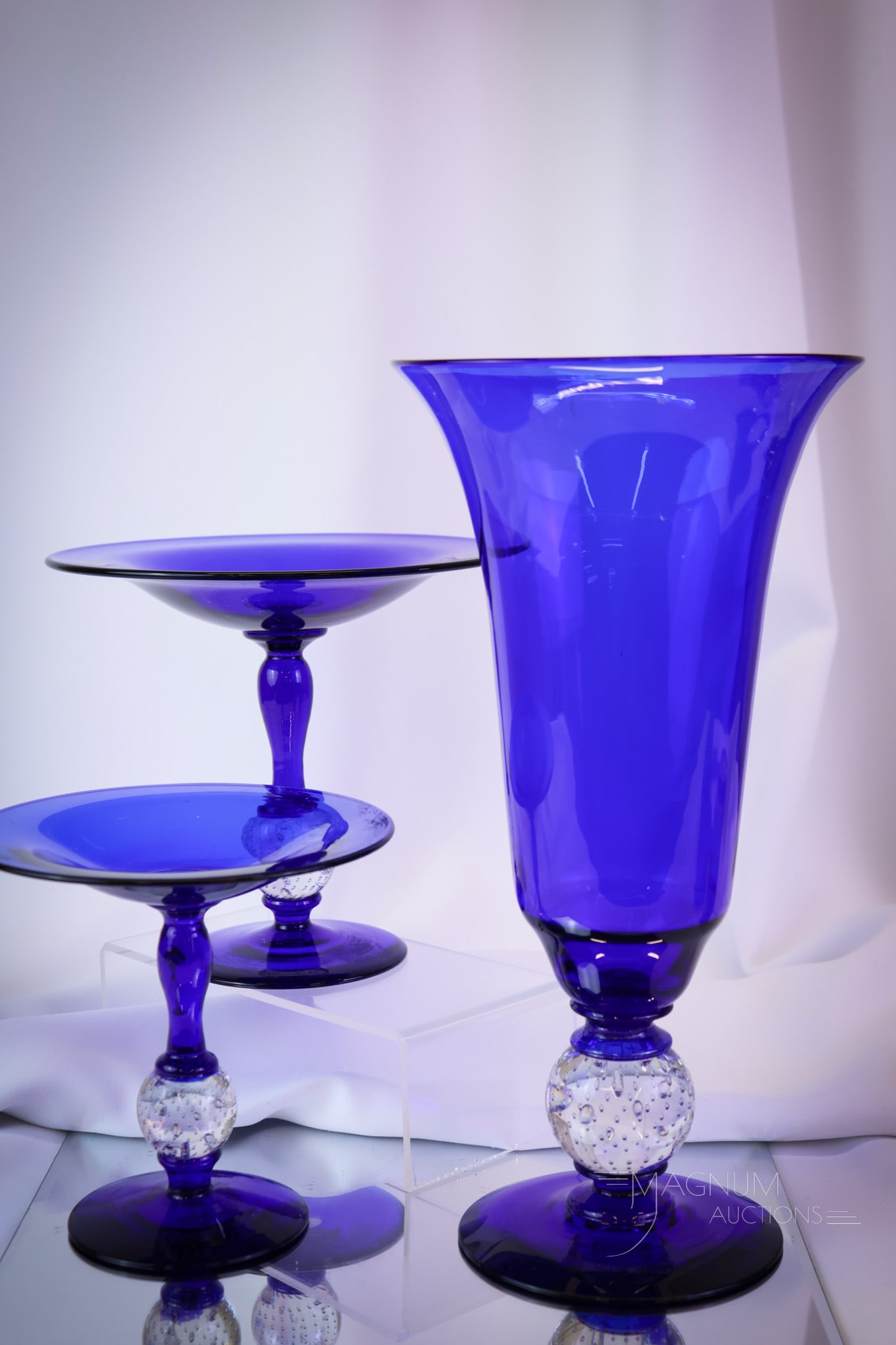 3 pc Lot Pairpoint Cobalt Blue Controlled Bubble Art Glass: Three selections that are sure to please in this offering of Pairpoint art glass. This lot includes a large vase and two compotes of different sizes.. The tallest measures 13". SHIPPING NOTICE: If you
