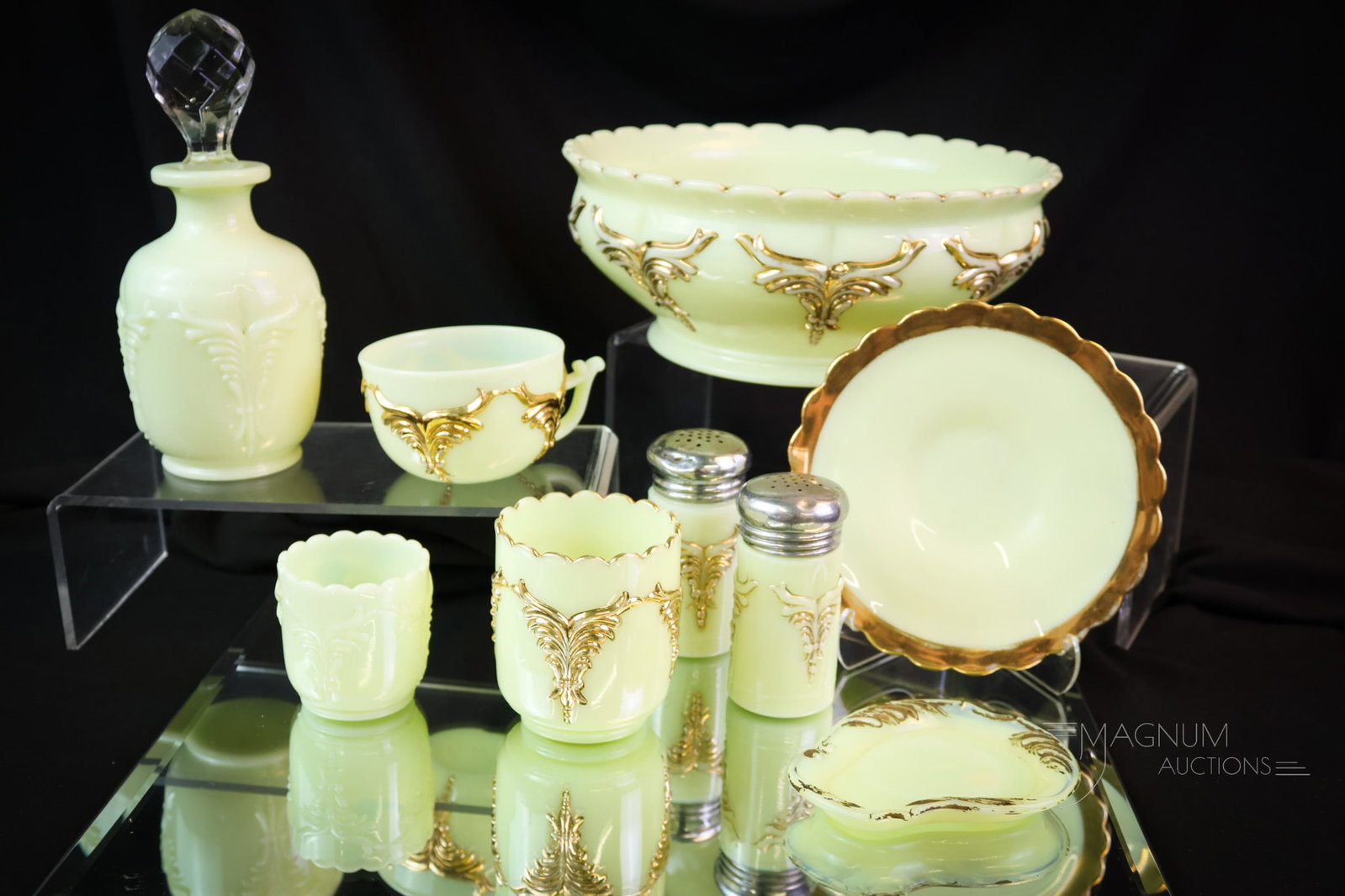 9 pc Lot Victorian Heisey Uranium Custard Glass: Nine finds in Victorian Uranium-rich custard glass. This lot includes a large berry bowl. A pair of shakers. A match holder and a toothpick. A cologne bottle, a pin dish, and a cup with a saucer. The 