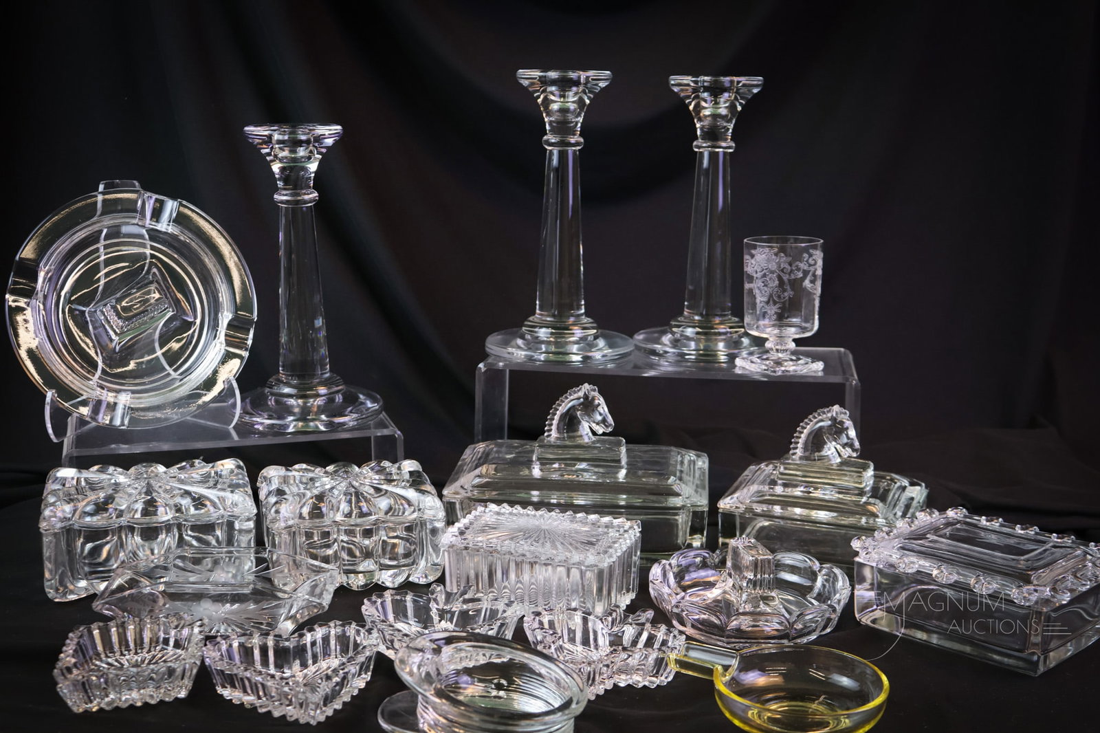 19 pc Lot Heisey Smoking & Related Glass Items: If your first love is Heisey and your second is cigarettes, this lot is made for you. This lot of smoking and related items includes six cigarette boxes, ten ashtrays, and three candlesticks. The tall