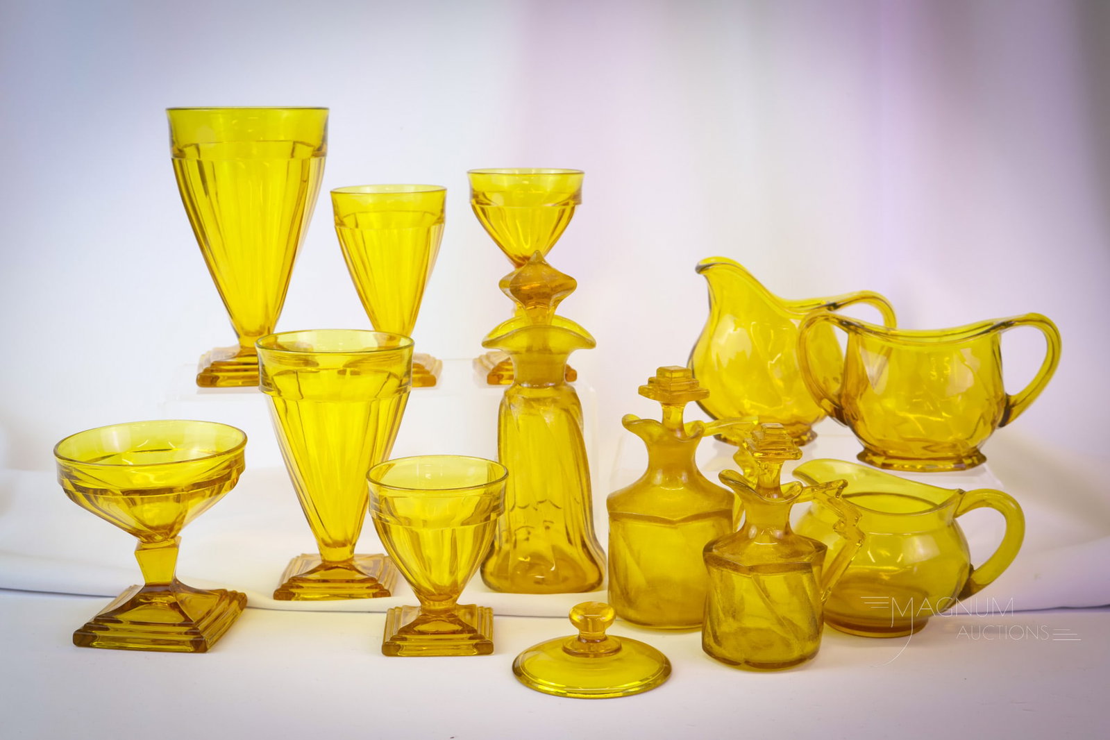13 pc Lot Heisey Twist Marigold Glass: A plentiful lot of Heisey glass in Marigold color in the Twist pattern. This lot includes, cruets, oil bottles, tumblers, and more. The tallest measures 7 1/2". SHIPPING NOTICE: If you choose not to u