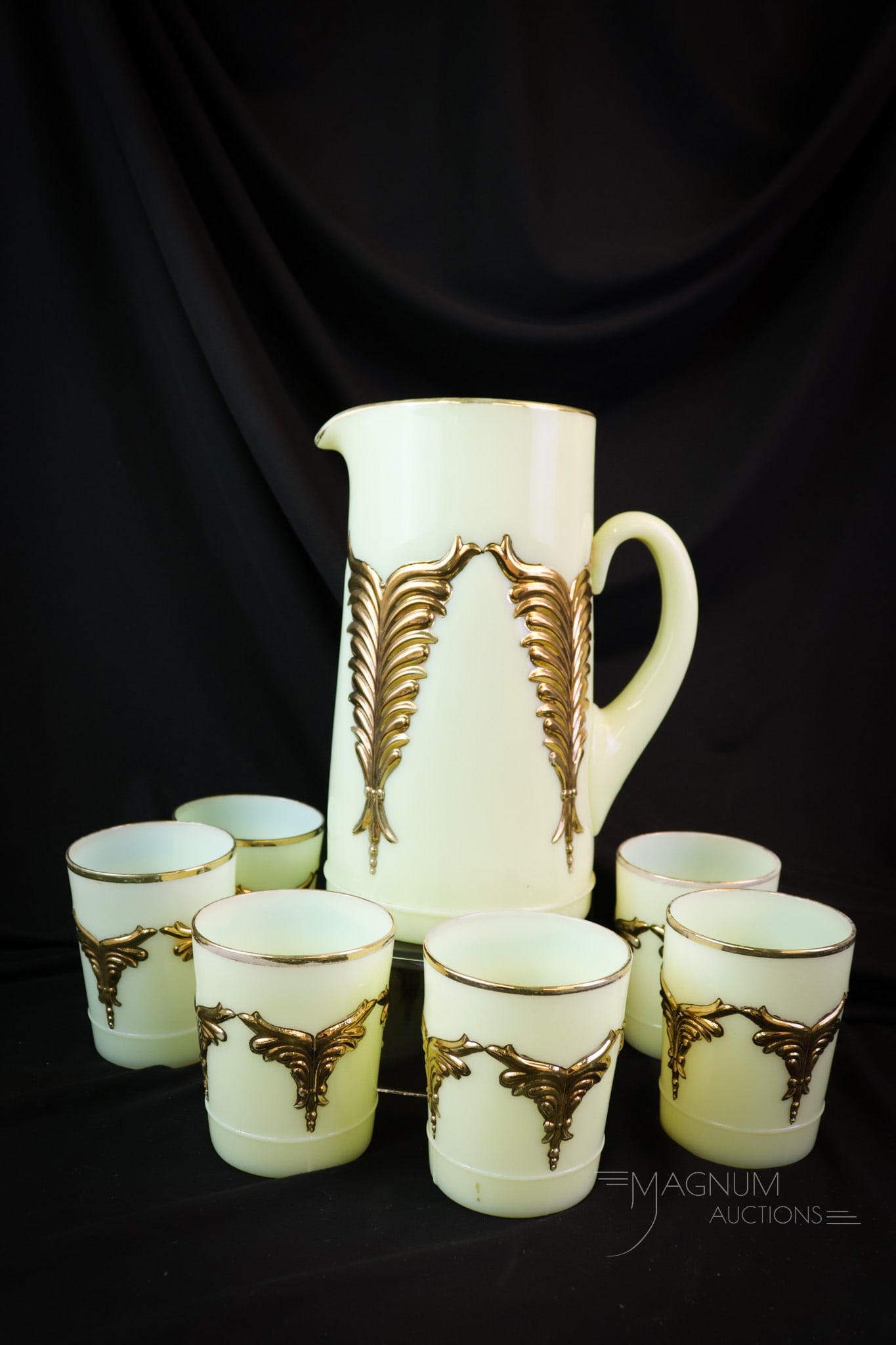 7 pc Heisey Victorian Uranium Gilt Custard Water Set: A gorgeous Uranium glass Victorian custard gilt decorated Winged Scroll pattern water set. This set lights up under black light. The tallest of the set measures 9 1/4". SHIPPING NOTICE: If you choose 