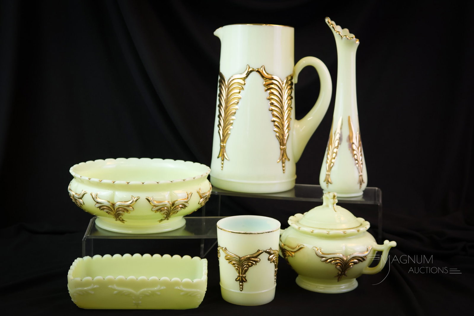 6 pc Lot Heisey Winged Scroll Uranium Custard Glass: Six glowing finds in the Heisey Winged Scroll pattern in uranium-rich custard glass. The tallest of the offering measures 9 1/2". SHIPPING NOTICE: If you choose not to utilize the LiveAuctioneers Live