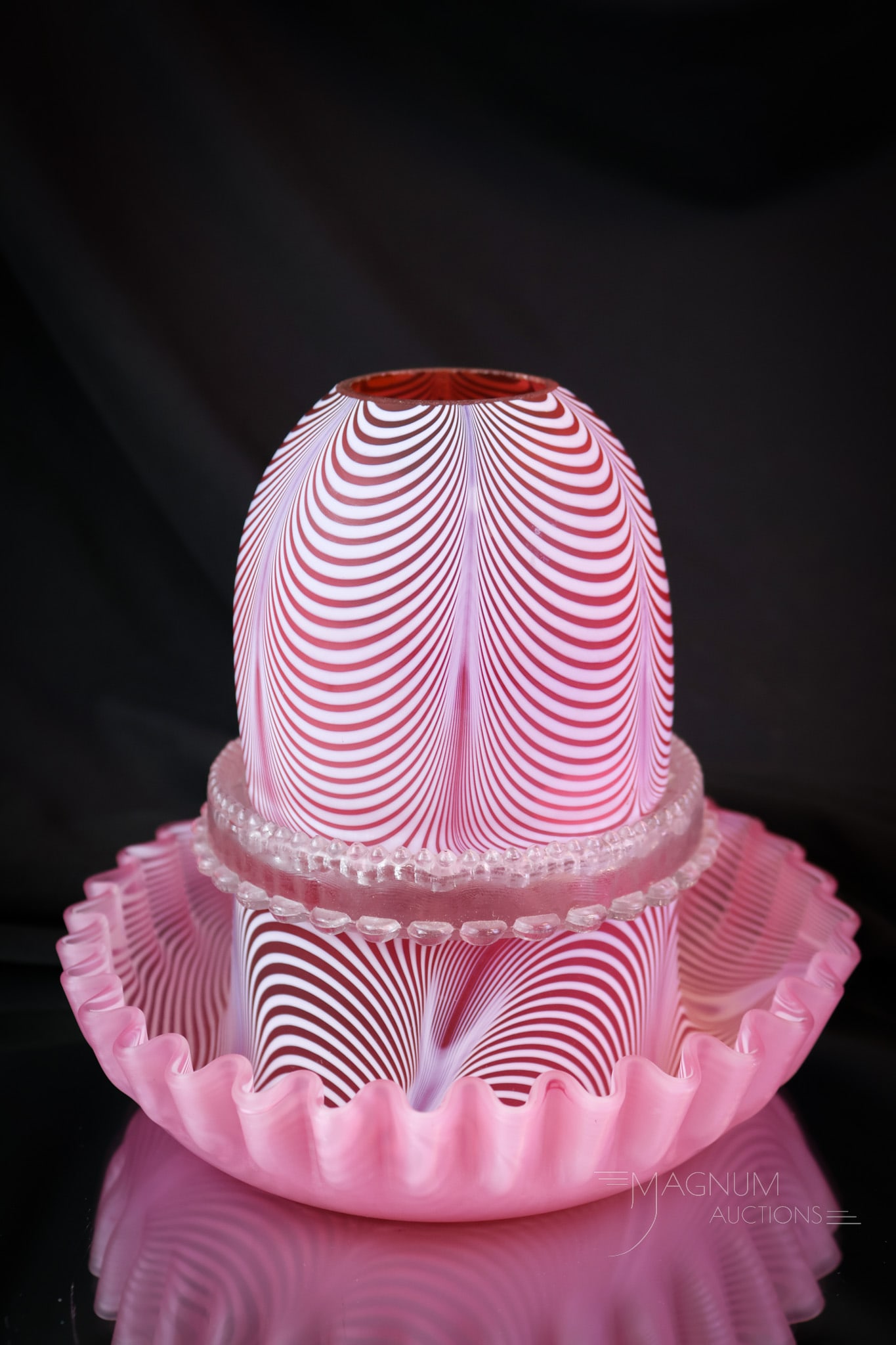 Cranberry Nailsea Victorian Glass Clarke Fairy Lamp: A classic form for a Nailsea Victorian Fairy Lamp. This lamp is found complete with the matching base. Great cranberry coloring. The lamp has a clear Clarke's candle cup. This lamp measures 5 1/2" tal