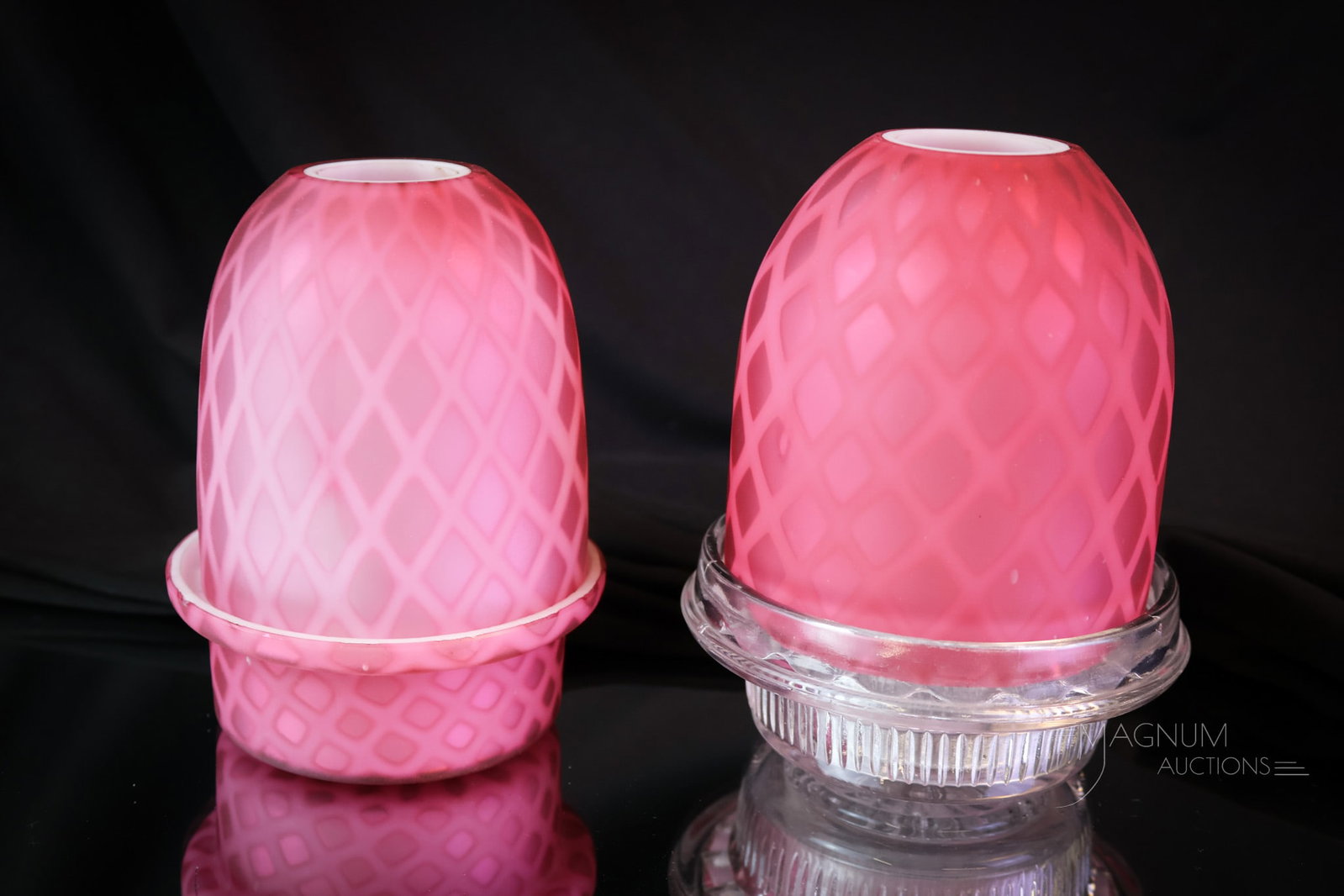 2 pc Lot Victorian Mother of Pearl Satin Glass Fairy Lamps: A two-piece lot of fairy lamp pleasures. This lot offers two lamps in deep pink diamond-quilt mother-of-pearl satin glass. One has a matching base. The other has a clear Clarke's insert and candle cup