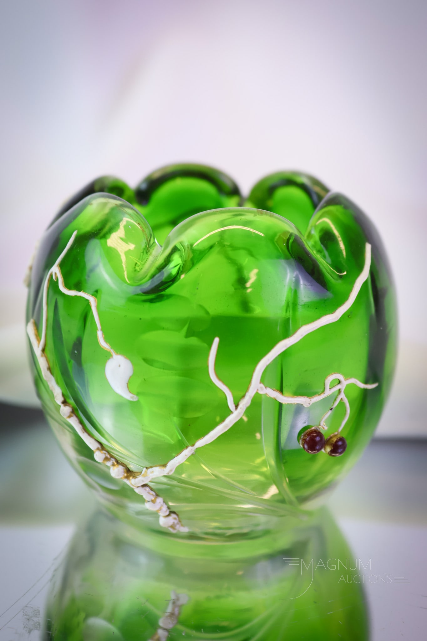 Moser Green Intaglio Glass Rose Bowl: A masterful find in Moser art glass. This is a rosebowl in green intaglio cut glass with white enameled vines and red berries. The rose bowl measures 2 1/2" tall and 3" wide. Minor losses to enameled