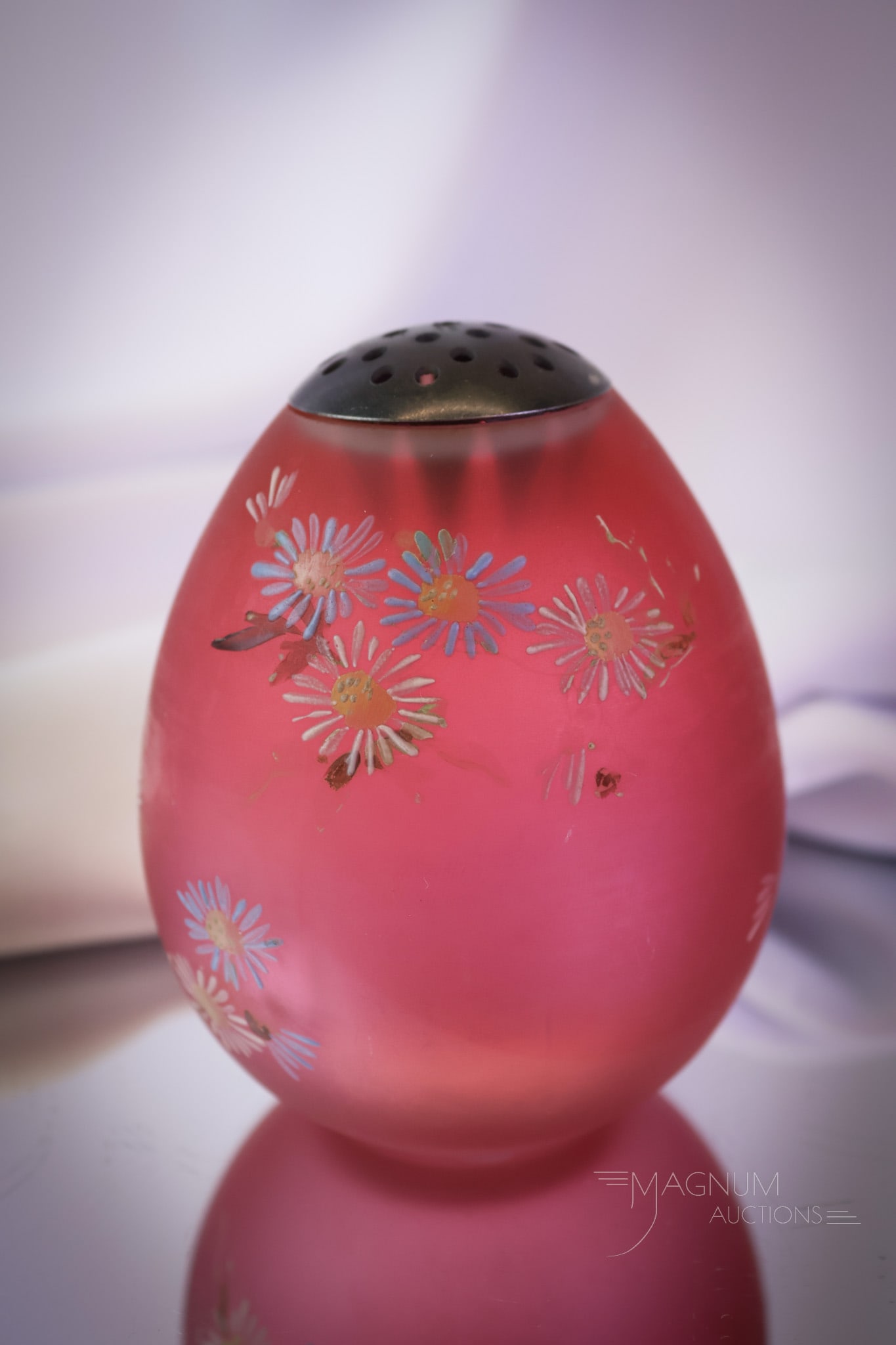 Mt. Washington Cranberry Victorian Enameled Glass Egg Sugar Shaker: A gorgeous find in Mt. Washington Victorian glass. This is an egg sugar shaker in rich cranberry satin glass. It is floral decorated. The shaker retains the orignal lid. It measures 3 1/2" tall and 3"