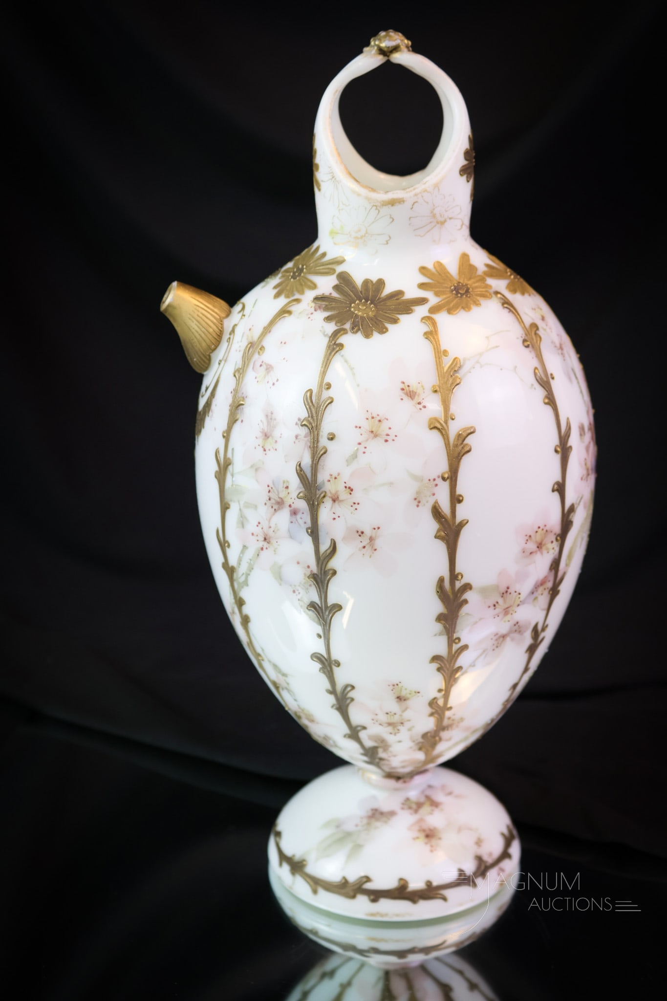 Mt. Washington Victorian Art Glass Colonial Ware 12" Pitcher: A wonderfully rare find in Mt. Washington Art Glass. This is a pitcher in Mt. Washington's Colonial ware line. The piece is decorated with gold and soft pink flowers. There's an applied raspberry prun