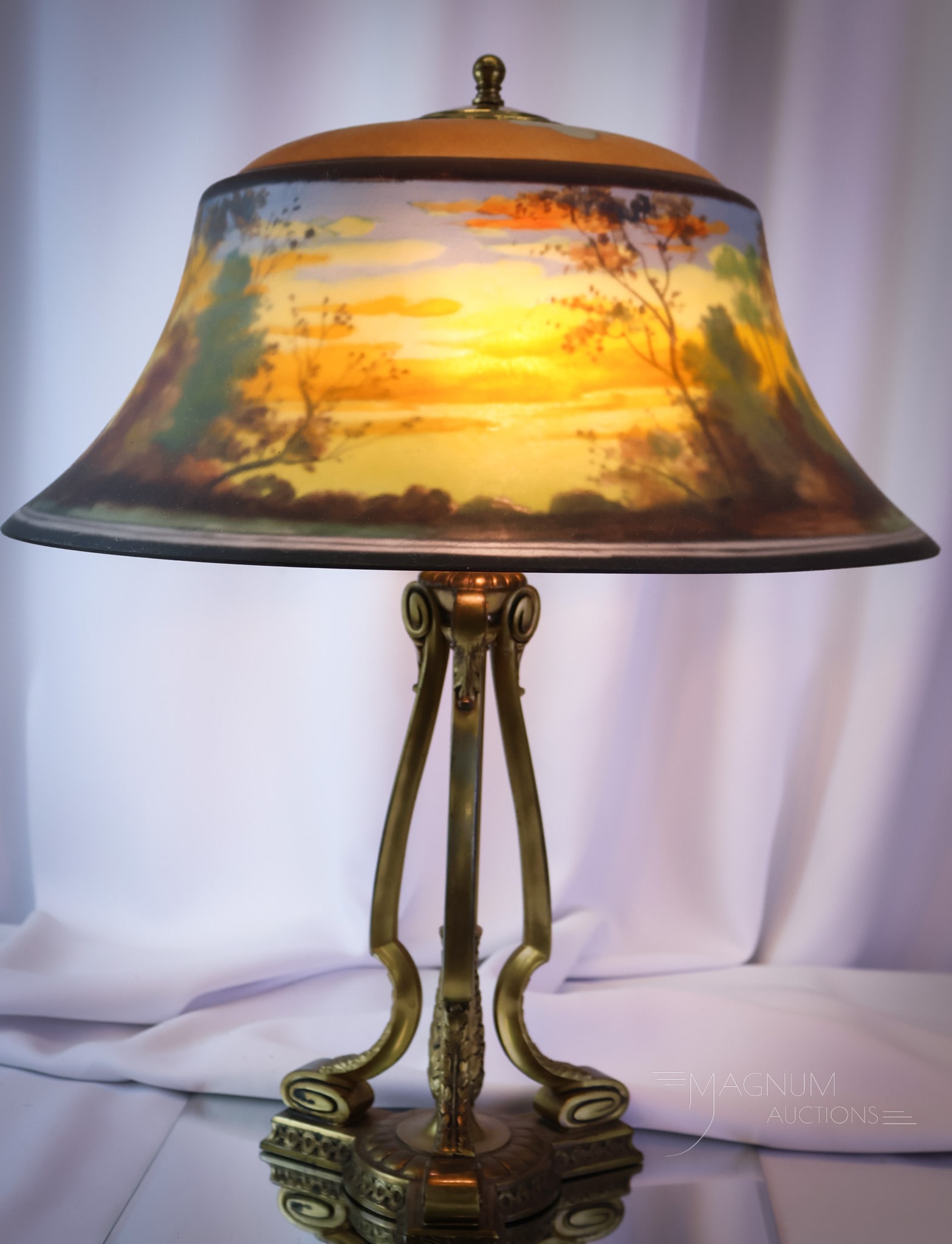 Pairpoint Reverse Painted Exeter Fall Scenic Reverse Painted Table lamp: Here's a classic and beautiful reverse-painted Pairpoint table lamp. This is an Exeter shape shade. It is decorated with a fall scenic decoration in harvest colors. It resides on a signed pairpoint ba