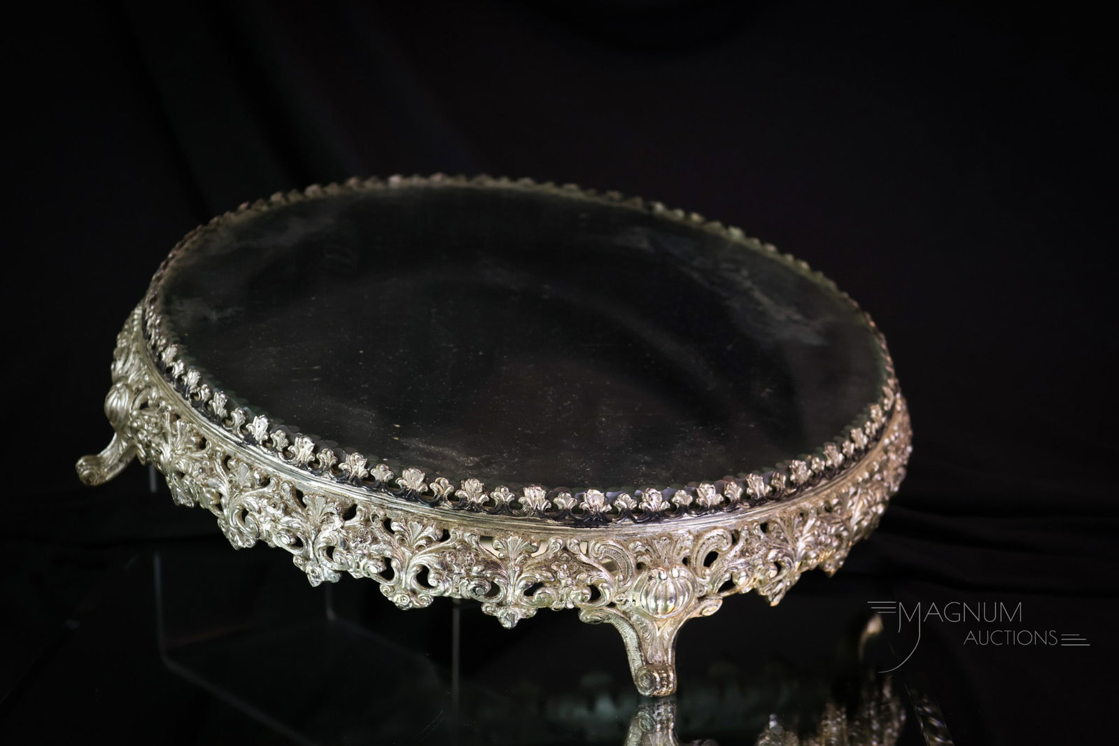Ornate Victorian Silverplate 13" Plateau Mirror: A perfect piece for showcasing your prized possession. This Victorian silverplated plateau mirror is very ornate. It features a beveled mirror. The piece measures 2 7/8" tall and 13" in diameter. SHIP