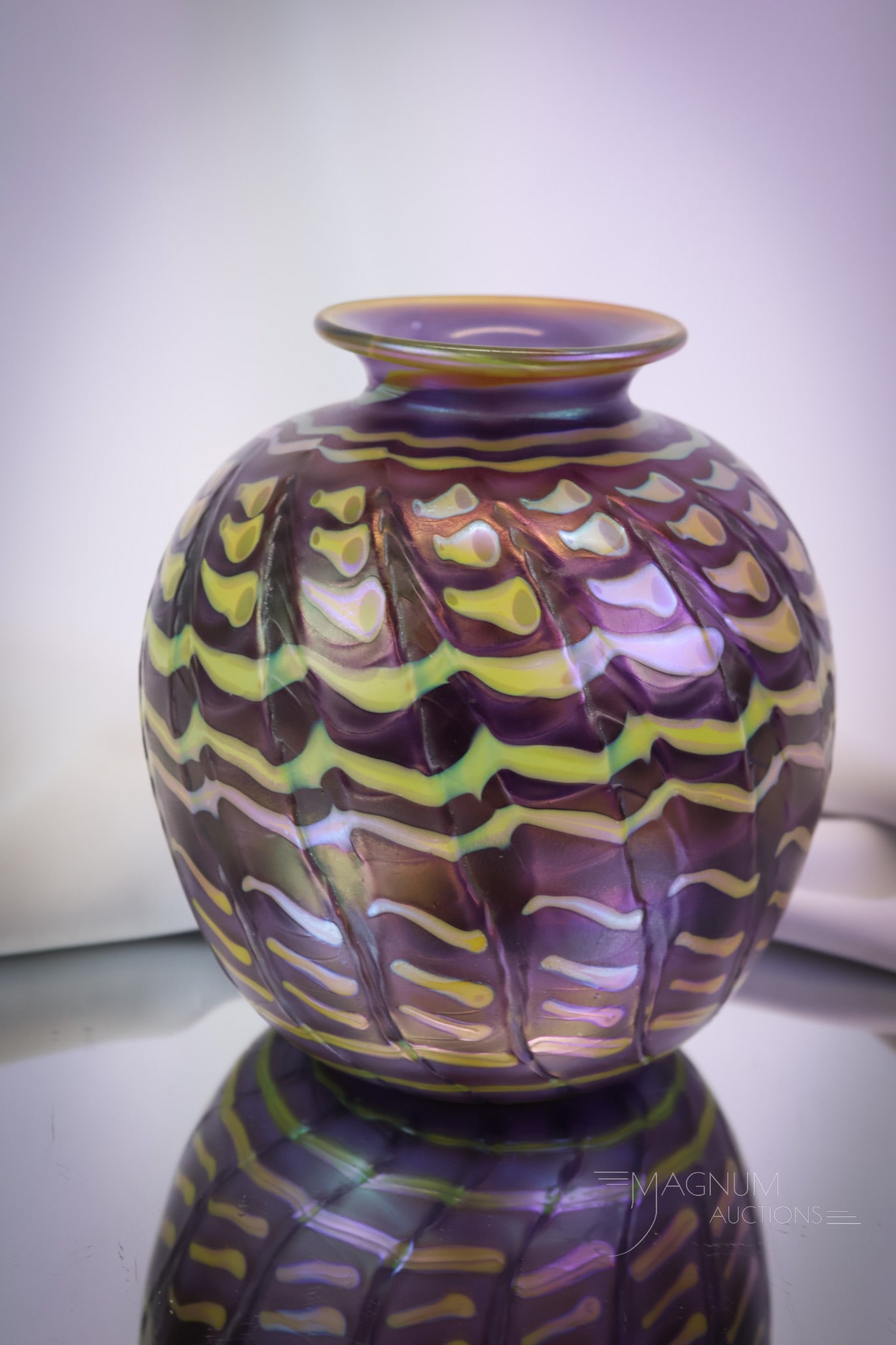 Jim Bush Iridescent Studio Art Glass Vase: A welcome addition to any collection. This is a signed Jim Bush Studio Art Glass vase. This vase features an abstract design in purple and chartreuse. The vase measures 7 1/2" tall. SHIPPING NOTICE: I