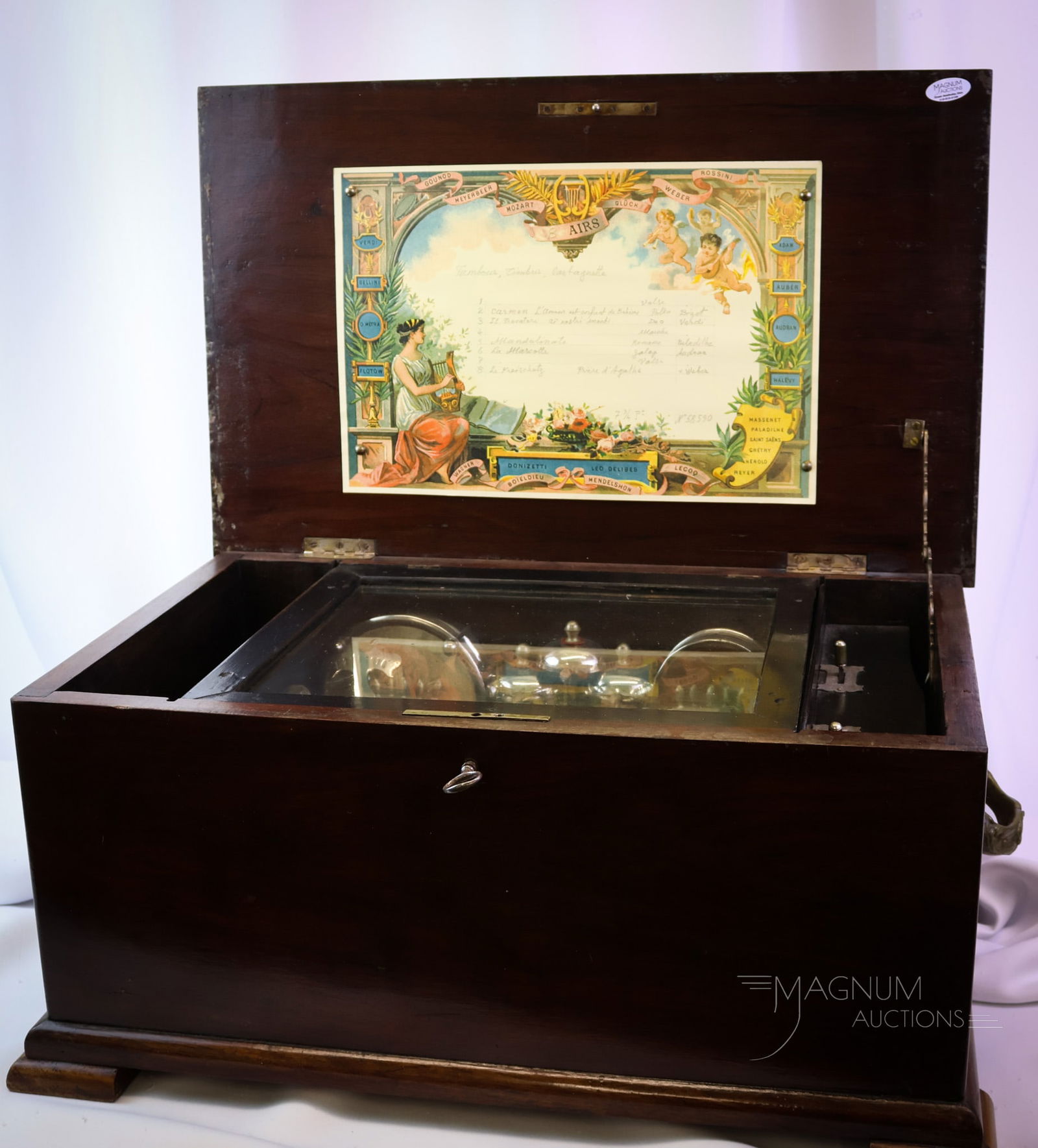 French Cylinder 8 Airs Music Box with Percussion: A French cylinder music box. This beautiful working-order piece plays eight tumes. The box features Tambour, Timbrus, and Castagnette. The piece retains the original case in fine condition. It measure