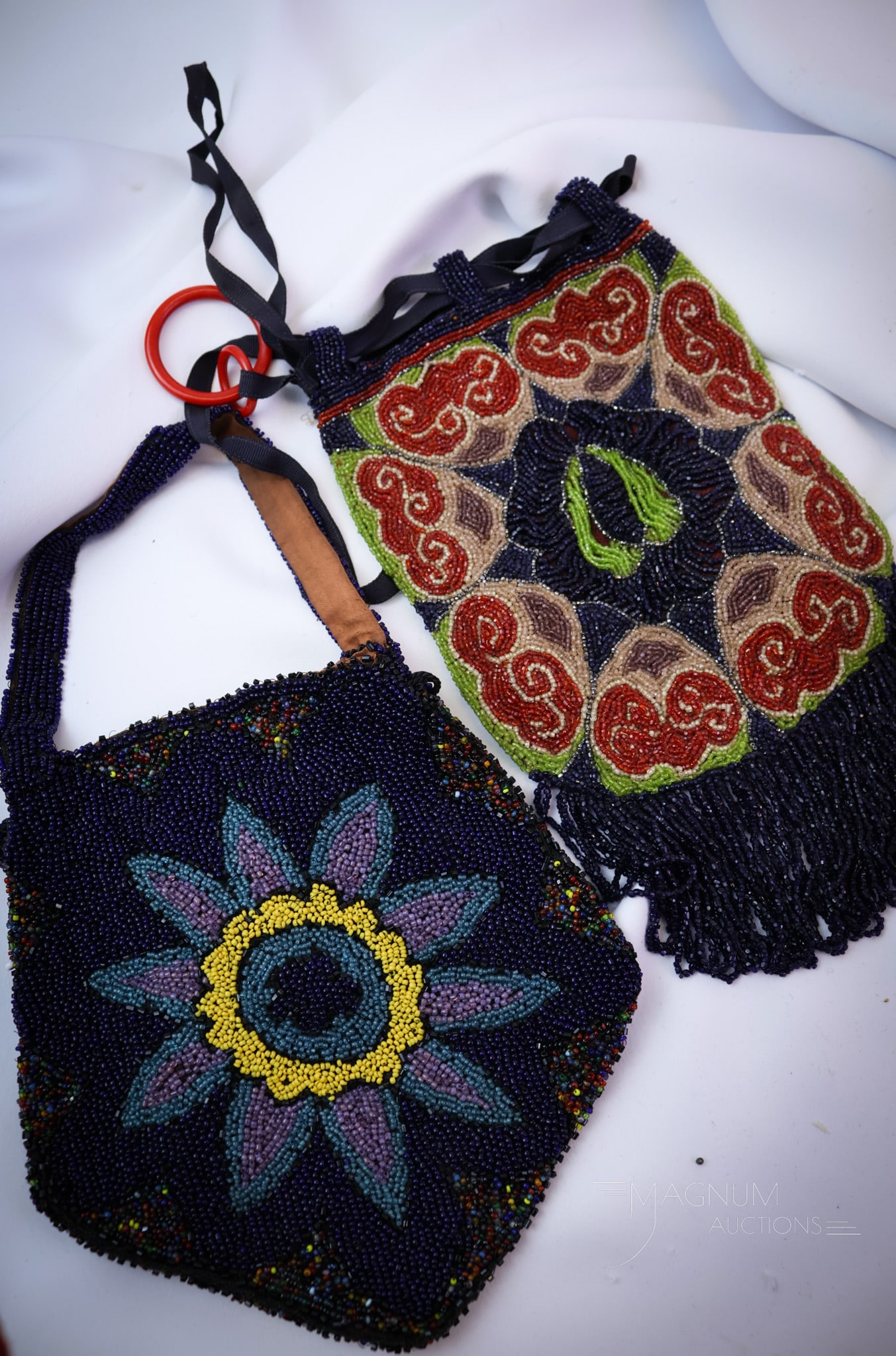 2 pc Lot Antique Beaded Evening Bags: Two desirable finds in antique beaded evening bags. Each is eloquently adorned with glass beads. The largest measures 5 3/4" by 10". SHIPPING NOTICE: If you choose not to utilize the LiveAuctioneers L