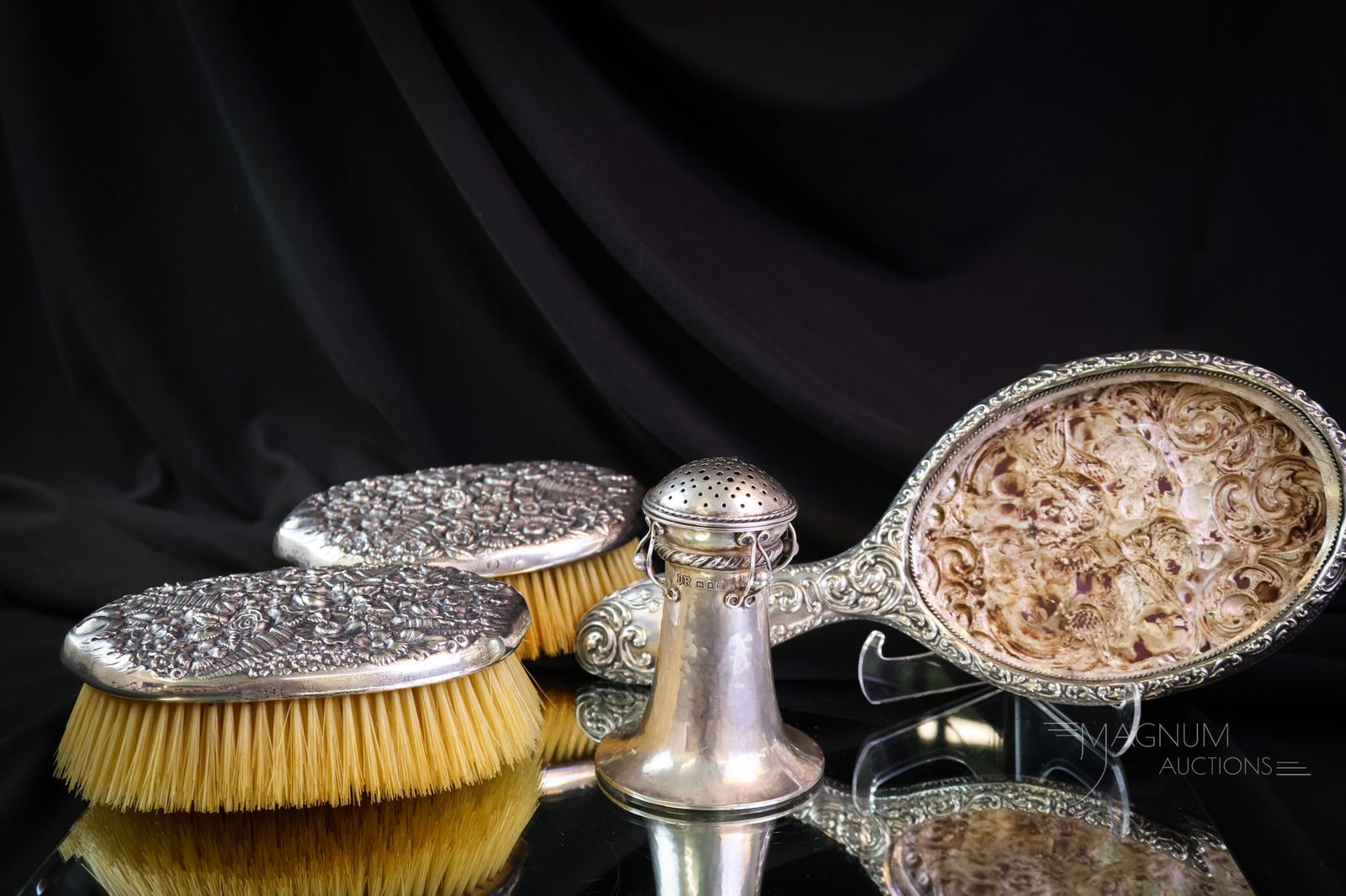 4 pc Lot Sterling Silver Tiffany & More: Four beautiful finds in antique sterling silver. This lot includes two signed Tiffany brushes, a hand mirror with cherubs(less mirror), and an English hallmarked talcum shaker. Each is a beautiful exa