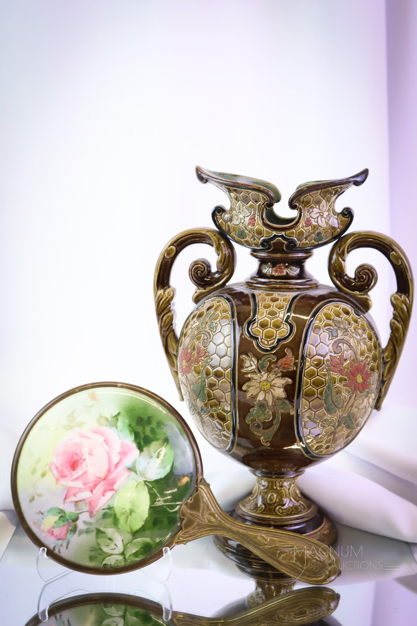 2 pc Lot Roses Hand Painted Porcelain Hand Mirror & Vase: two unique finds in Victorian items. The first is a porcelain hand-painted rose decorated hand mirror. The second is an earthenware decorated vase. The tallest measures 11". SHIPPING NOTICE: If you ch