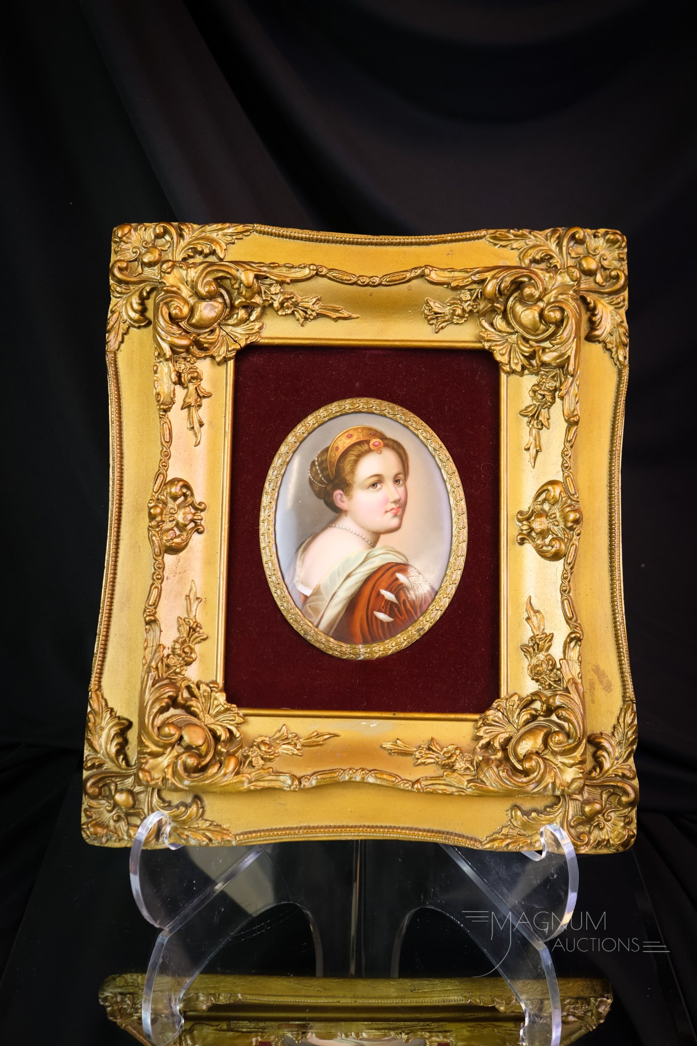Antique Framed Porcelain Portrait Plaque: A decorative antique porcelain portrait plaque. This fine piece is framed in a gilt Rococo gesso frame. The frame measures 11 by 13". The plaque measures 5" by 4". The portrait is of a young woman wit