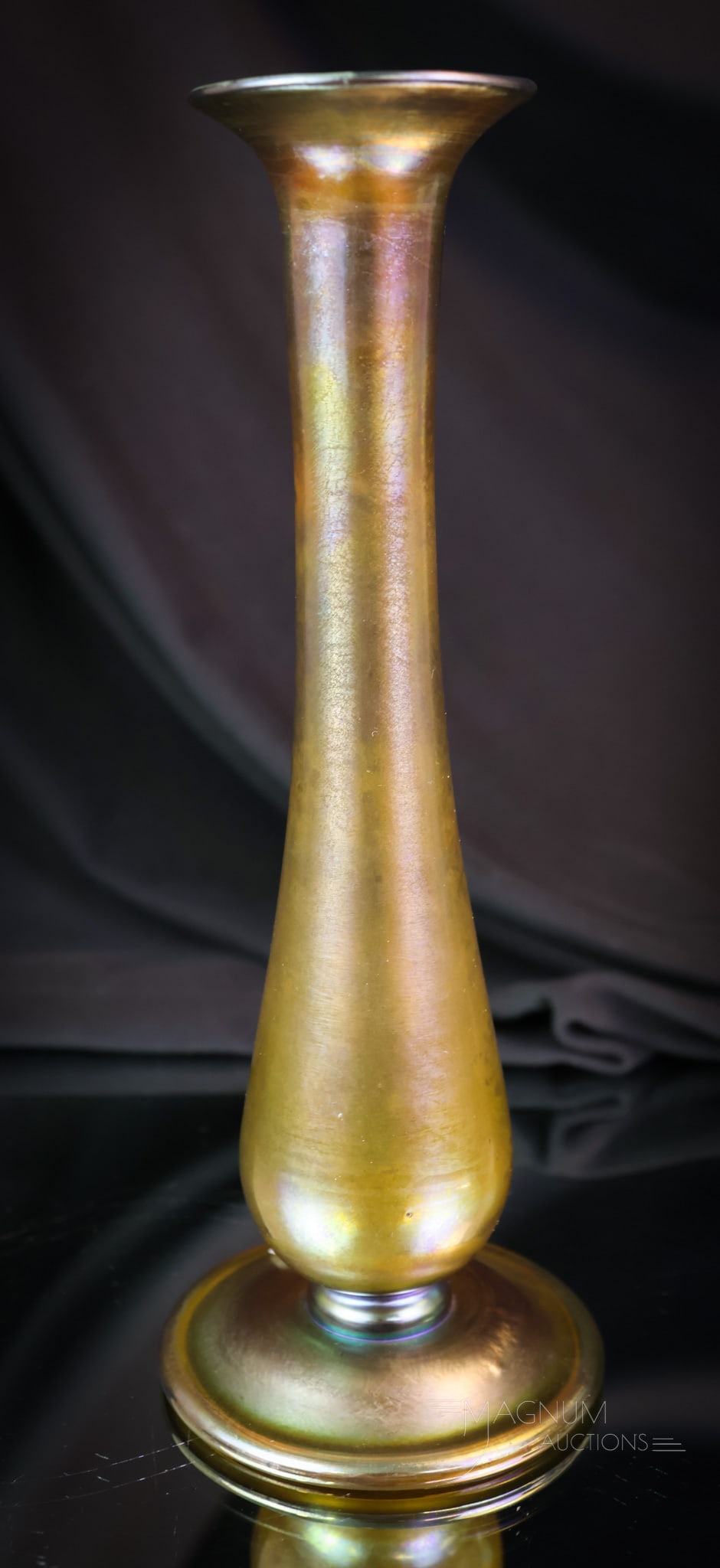 L.C. Tiffany Gold Favrile Art Glass Bud Vase: A fine L.C. Tiffany gold favrile iridescent art glass bud vase. This piece is marked "9275 L.C. Tiffany Favrile" and "1501." The vase measures 8" tall and 3" wide. SHIPPING NOTICE: If you choose not t