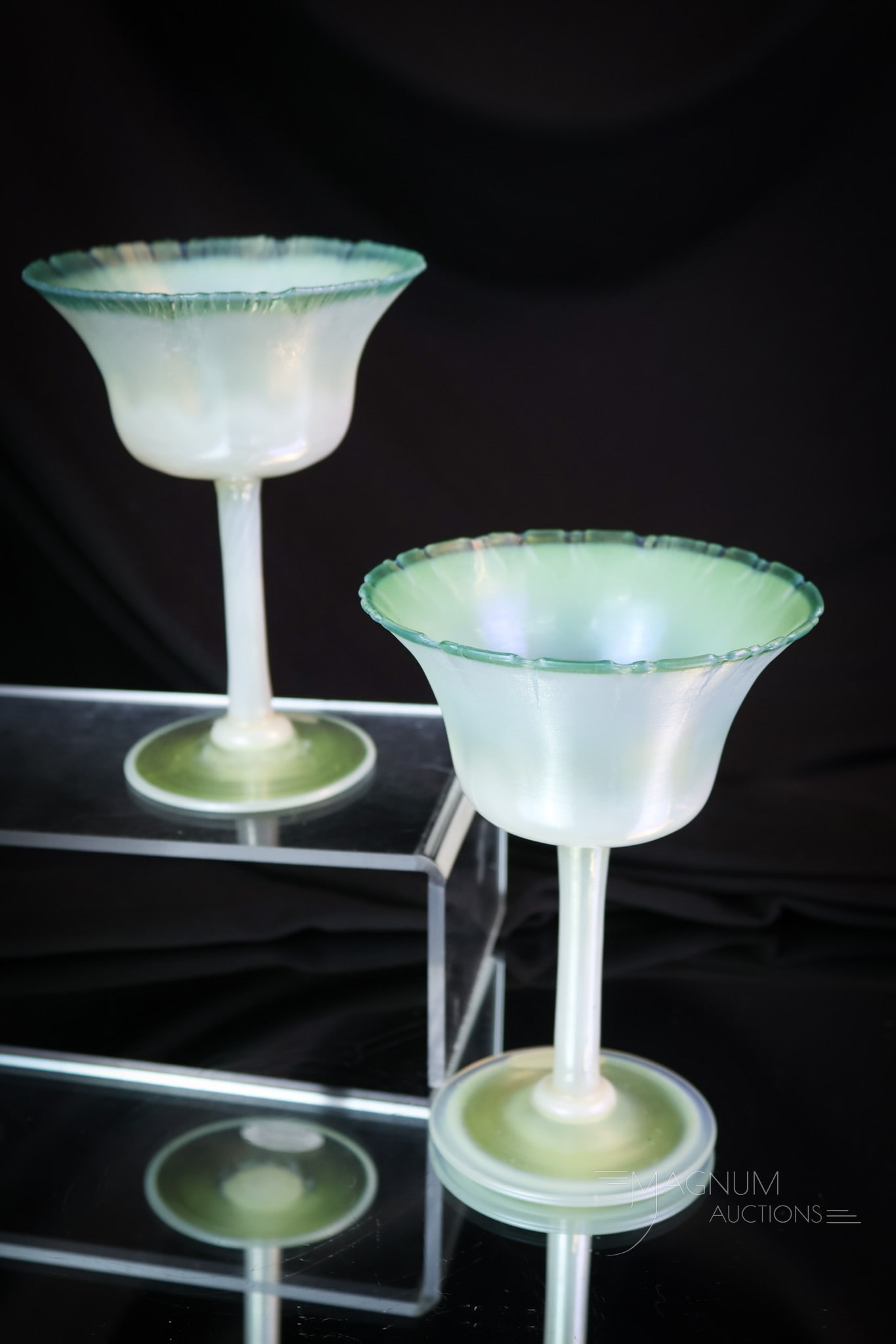 2 pc Lot L.C. Tiffany Favrile Pastel Art Glass Dessert Stems: An additional two delightful examples of L.C. Tiffany pastel Favrile art glass. This pair of dessert stems is in green opal pastel coloring. Each is marked "L.C.T. Favrile, 1774." Each measures 5 1/2"