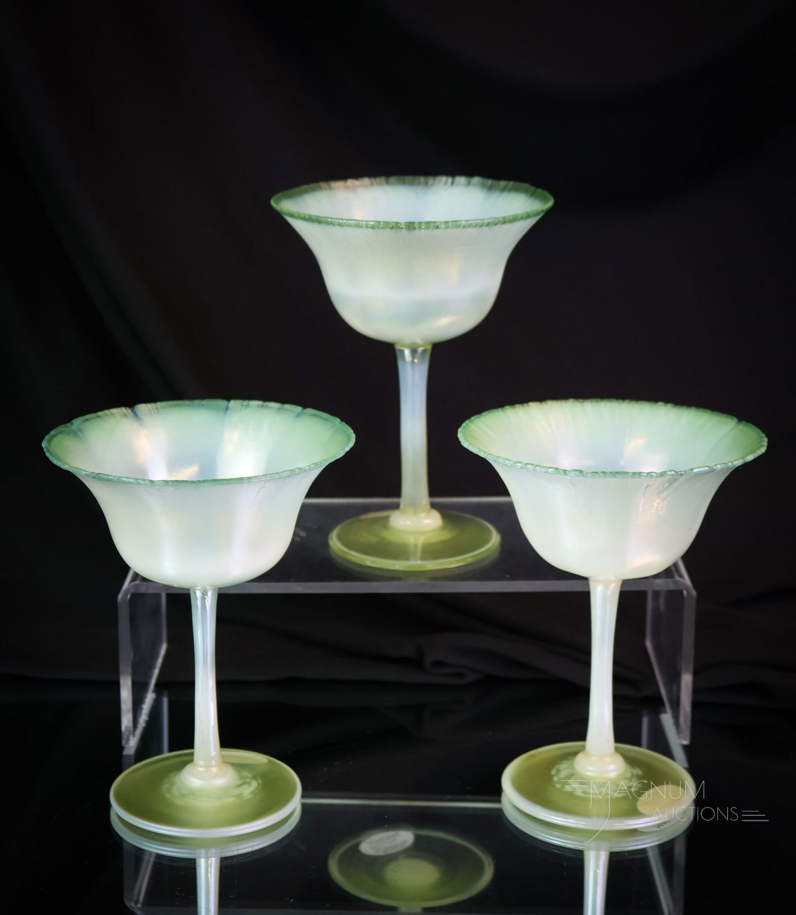 3 pc Lot L.C. Tiffany Favrile Pastel Green Art Glass Dessert Stems: A nice grouping of three green pastel L.C. Tiffany green pastel art glass dessert stems. Each is marked "L.C.T. Favrile 1774." Each measures 5" tall and 4" wide. SHIPPING NOTICE: If you choose not to