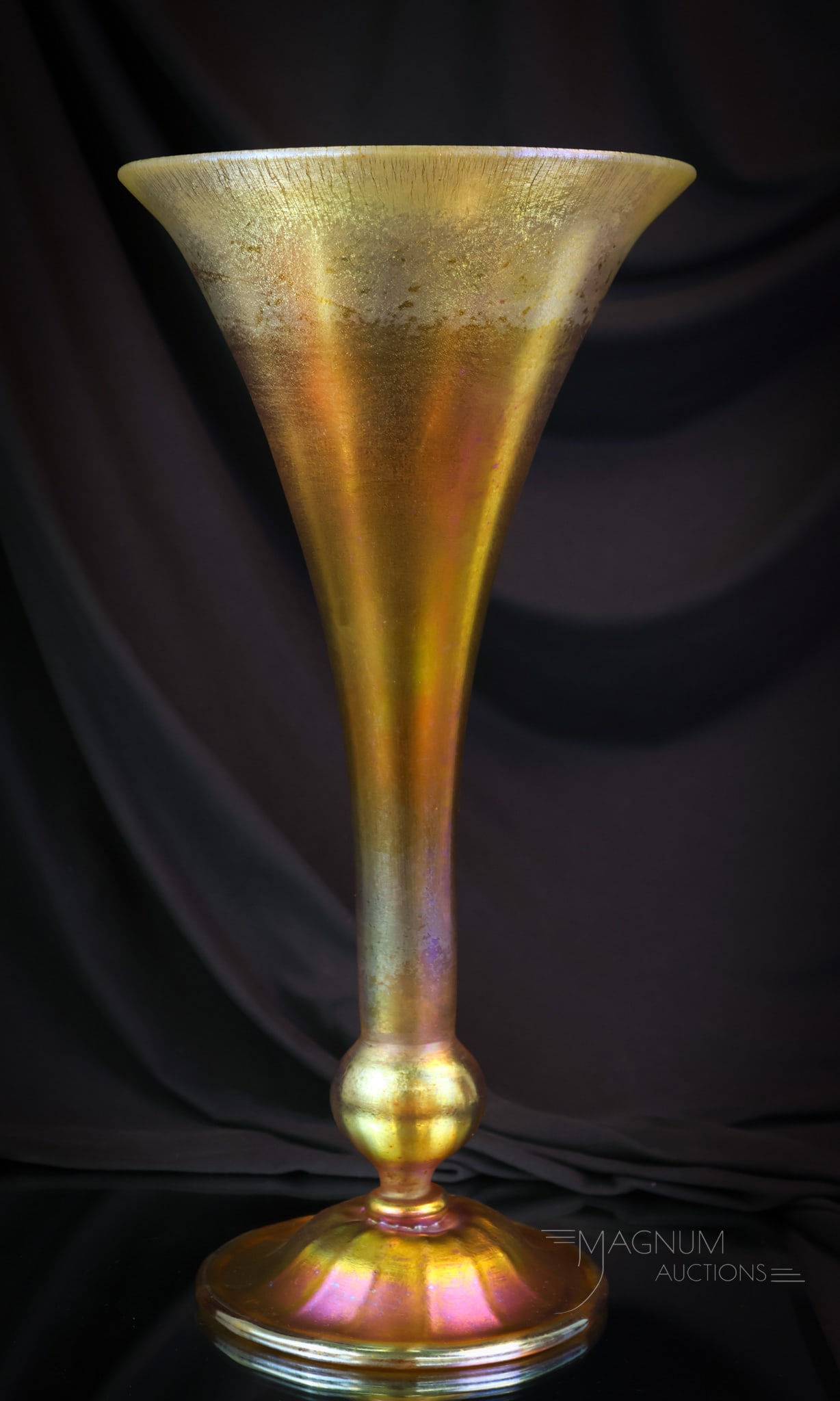 Monumental 15" L.C.Tiffany Gold Favrile Iridescent Trumpet Vase: A monumental find in gold iridescent L.C. Tiffany Favrile art glass. This is a trumpet form vase with a ball stem and flared form. This vase measures 15 1/4" tall and 8" wide. It has unbelievable colo