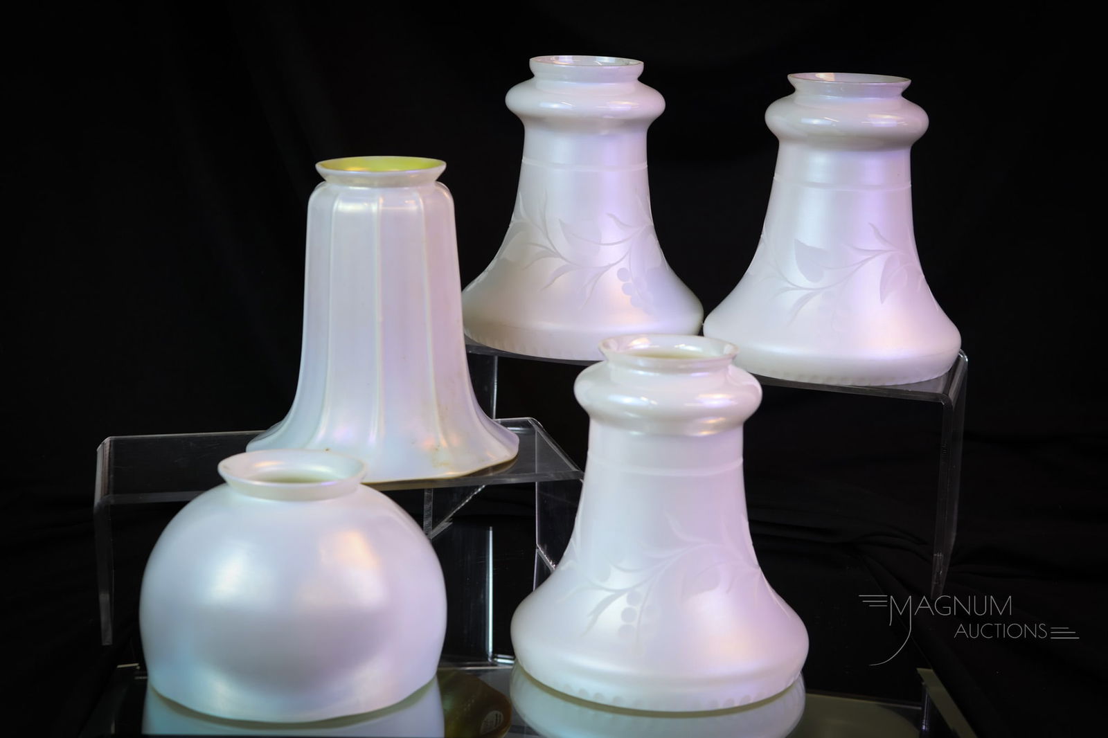 5 pc Lot Steuben Iridescent Art Glass Shades Calcite & Aurene: Here's a lot of five Steuben art glass shades. The lot includes a set of three matching Calcite examples. Each is engraved with a Leaf and Berry design. All are marked. These measures 5 1/4" tall, 5"