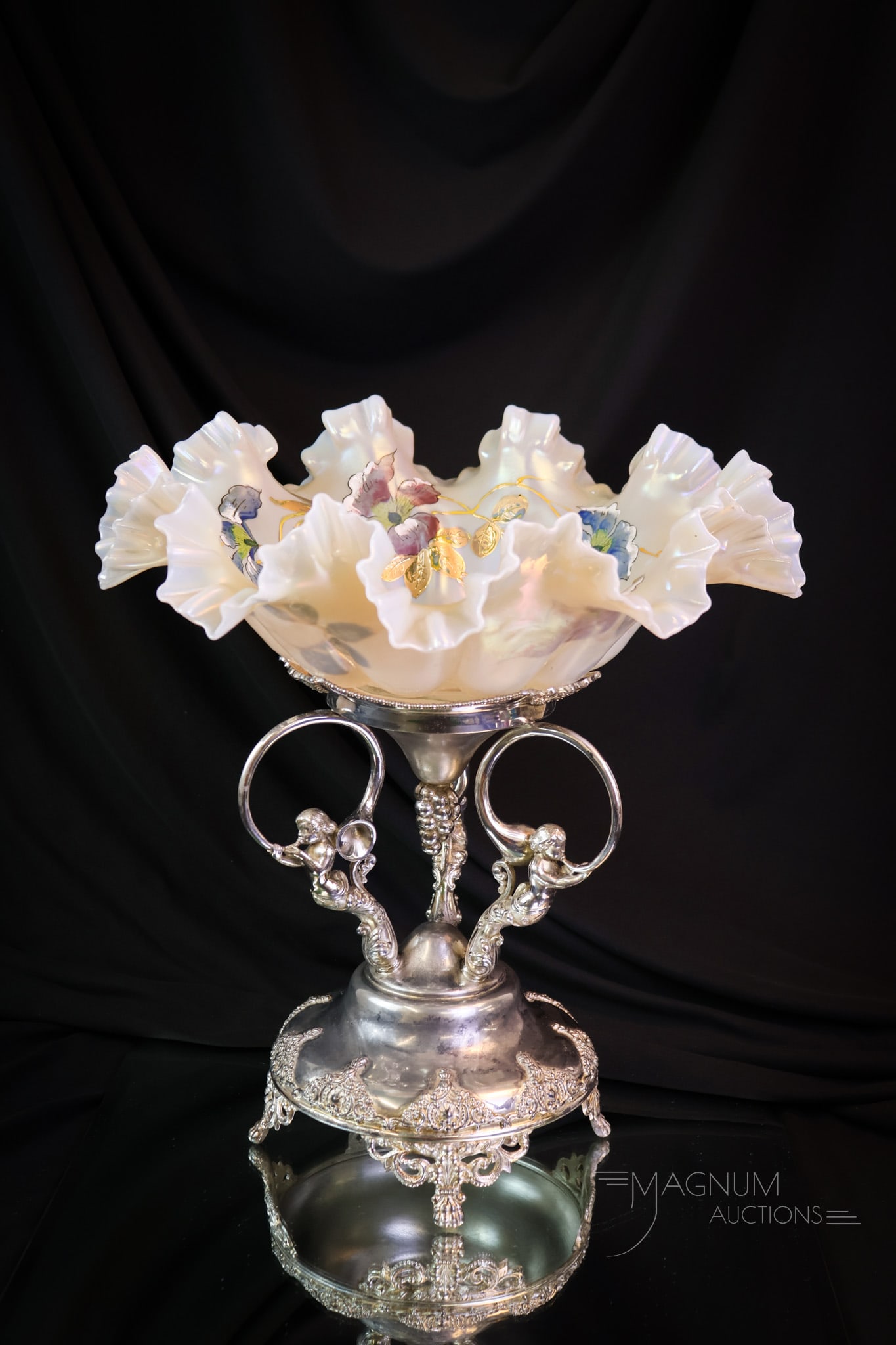 Tufts Figural Silverplate Iridescent Enameled Glass Brides Bowl Centerpiece: What a showy piece this is! There are three figural putti with French horns at the base of this signed Tufts silverplate holder. It perfectly displays a creamy opal iridescent art glass bride bowl. Th