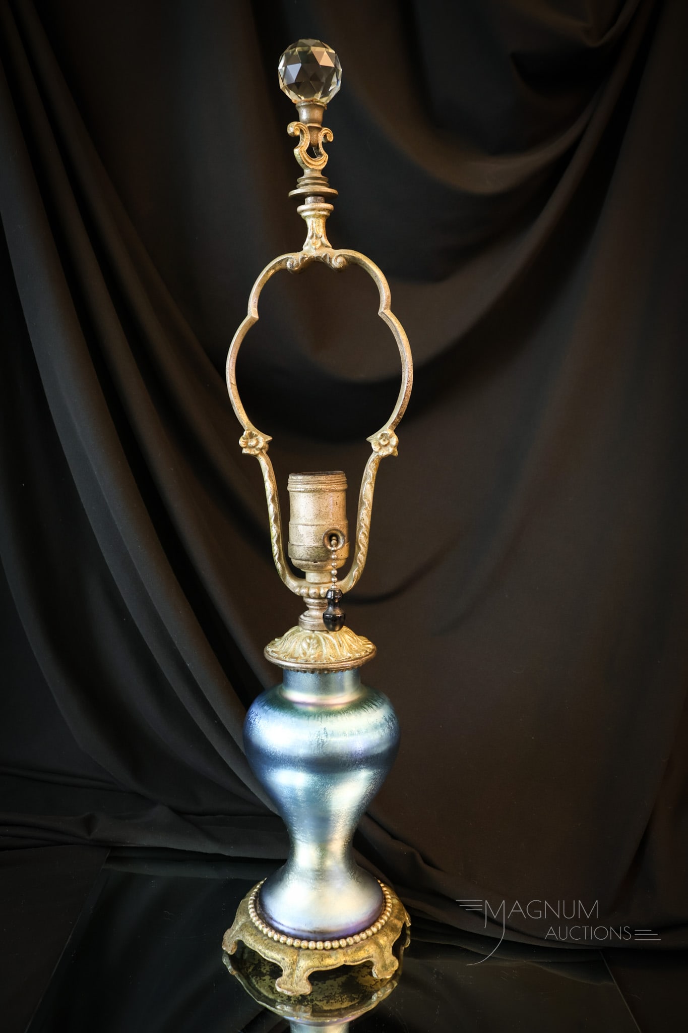 Steuben Blue Aurene Antique Art Glass Table Lamp: A beautiful find in Steuben blue Aurene art glass in the form of a table lamp. This baluster form lamp features original hardware. The lamp measures 20 1/2" tall and 4 1/4" wide. A replacement crystal