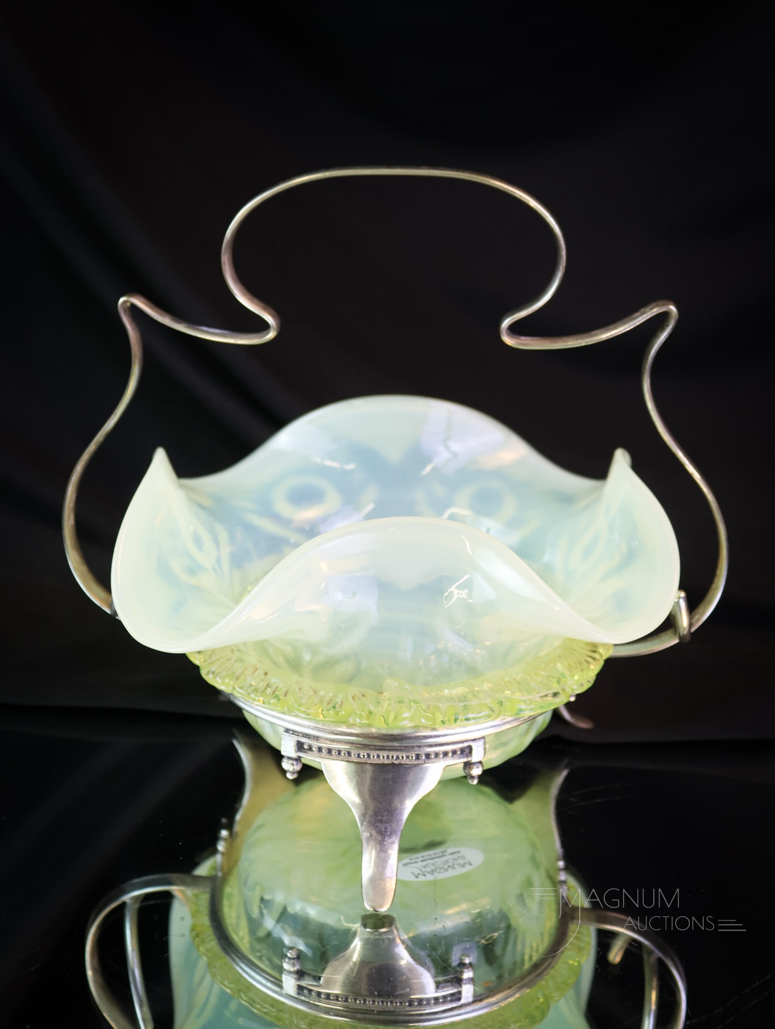 English Victorian Silverplate & Uranium Vaseline Art Glass Sweetmeat: Another quality find in our auction. This is an English Victorian sweetmeat in a silverplate holder. This beautiful example is in uranium-rich vaseline glass with applied rigaree and floral design. It