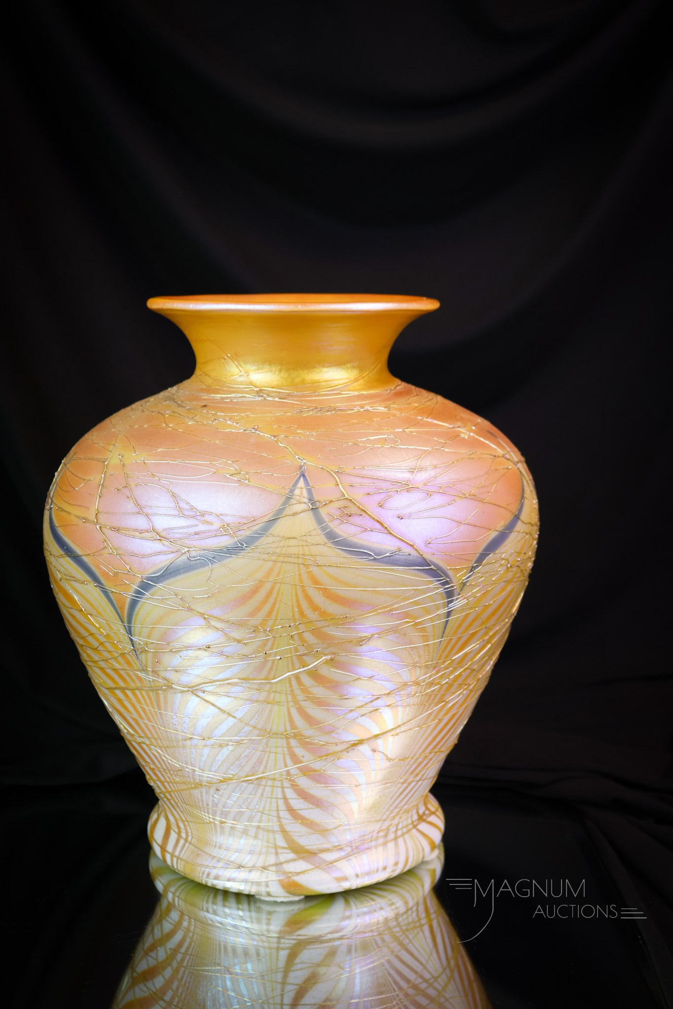 Durand 11" Pulled Feather Iridescent Art Glass Vase: A massive and imposing Durand art glass vase. This huge example is in iridescent glass with threading and a pulled feather design. The vase was once drilled for a lamp base. This piece measures 11" ta