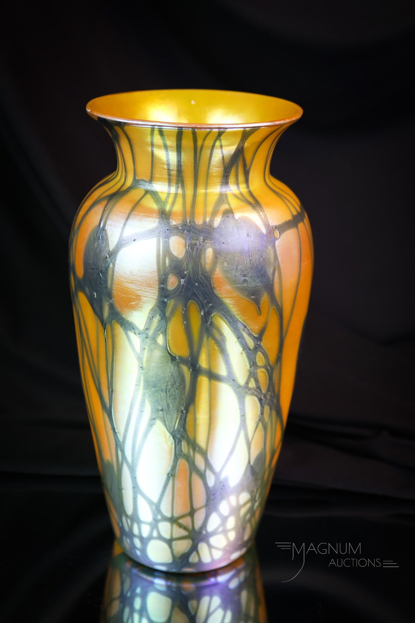 Durand Gold Iridescent Art Glass Heart & Vine 8 1/2" Vase: A striking Durand art glass vase in gold iridescent with black Heart & vVne decoration. This beautiful piece measures 8 1/2" tall and 4 1/4" wide. SHIPPING NOTICE: If you choose not to utilize the Liv