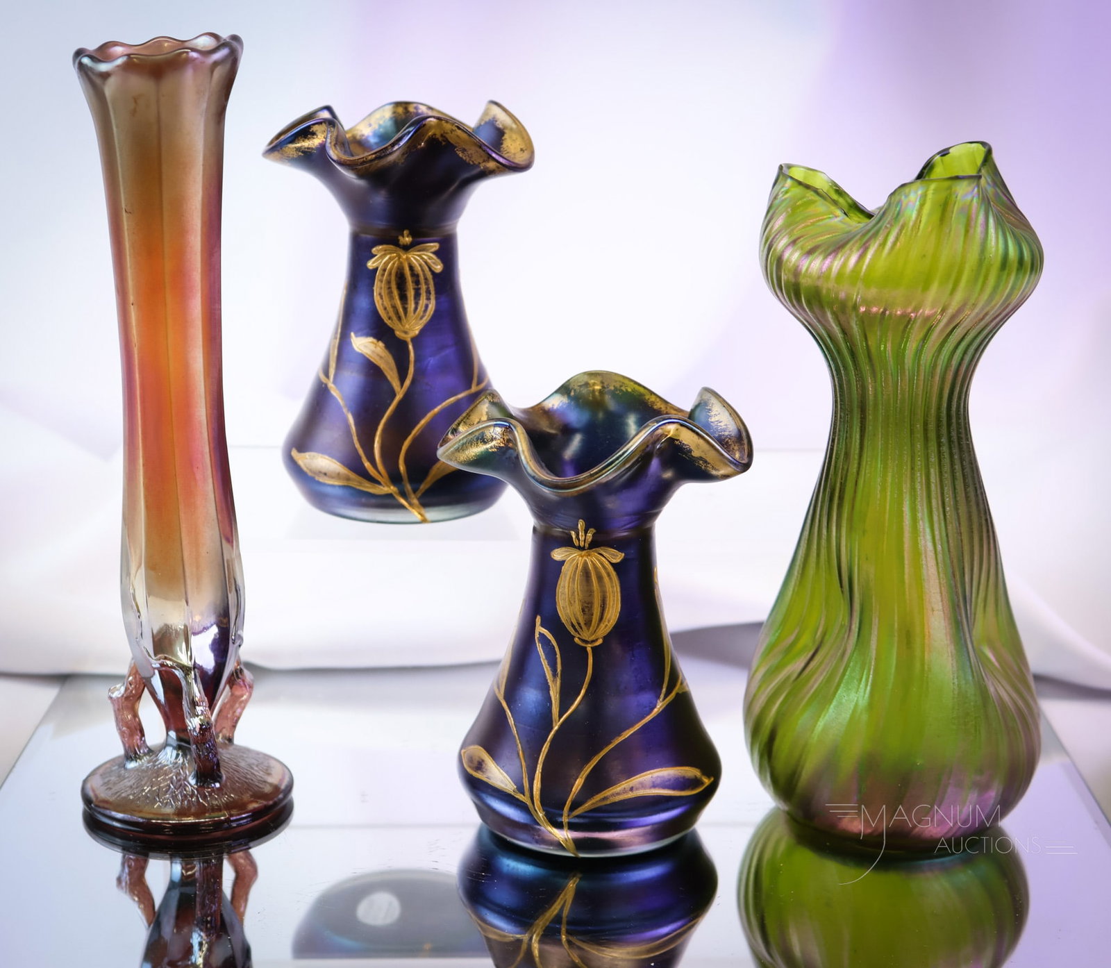 4 pc Lot Iridescent Art Glass Gilt Enameled Rindskopf Dugan & More Art Glass: Four select finds in iridescent art glass of the Art Nouveau period. This lot includes a pair of gilt enameled vases. Also a green Rindskopf ribbed example. The last is a Dugan Twigs carnival glass va