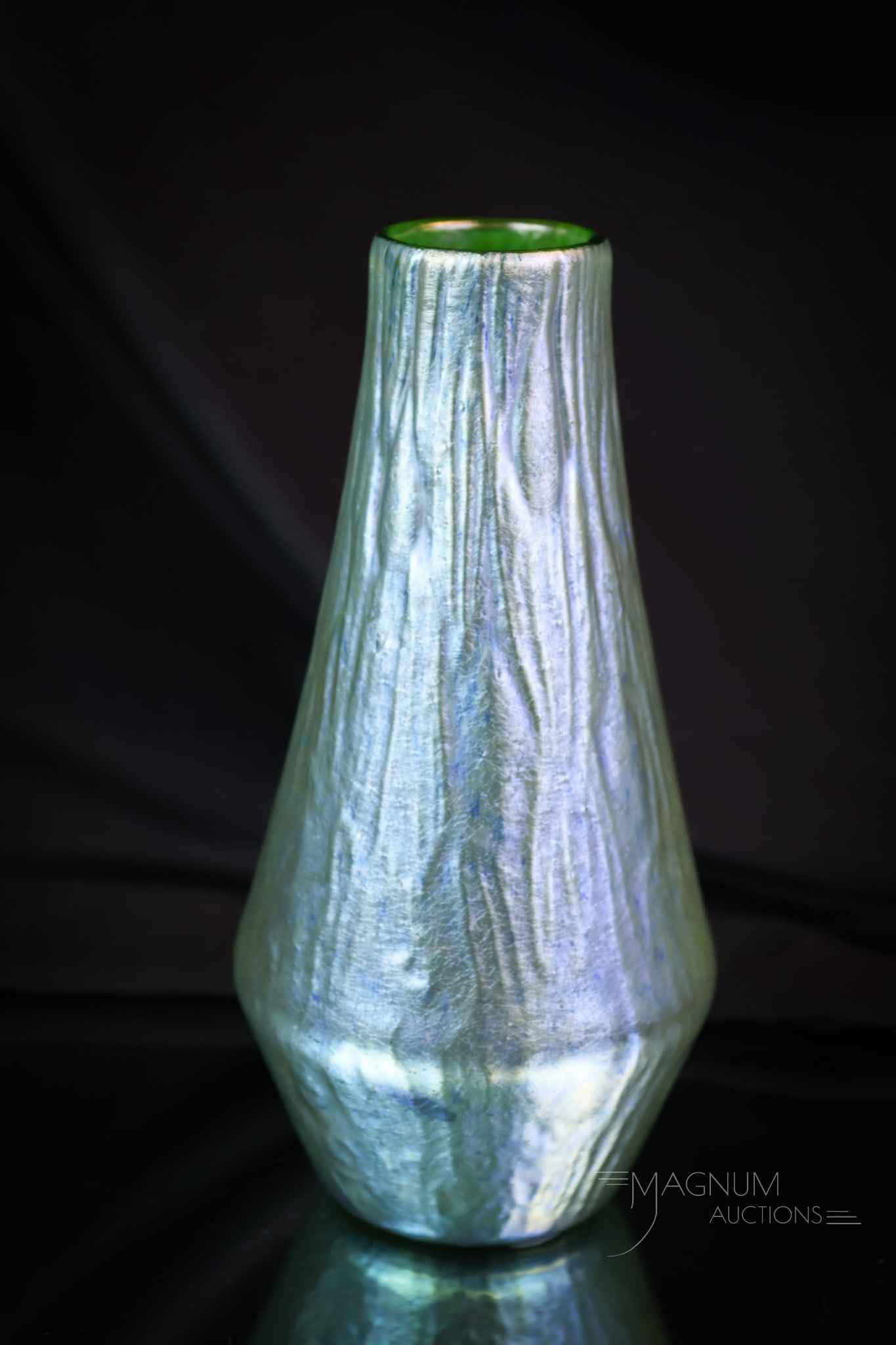 Loetz Crete Rusticana IridescentArt Glass Vase: Another find in Loetz art glass. This is a Crete Rusticana Vase. It measures 6 1/2" tall and 3" wide. SHIPPING NOTICE: If you choose not to utilize the LiveAuctioneers LiveShip program, MAGNUM AUCTION