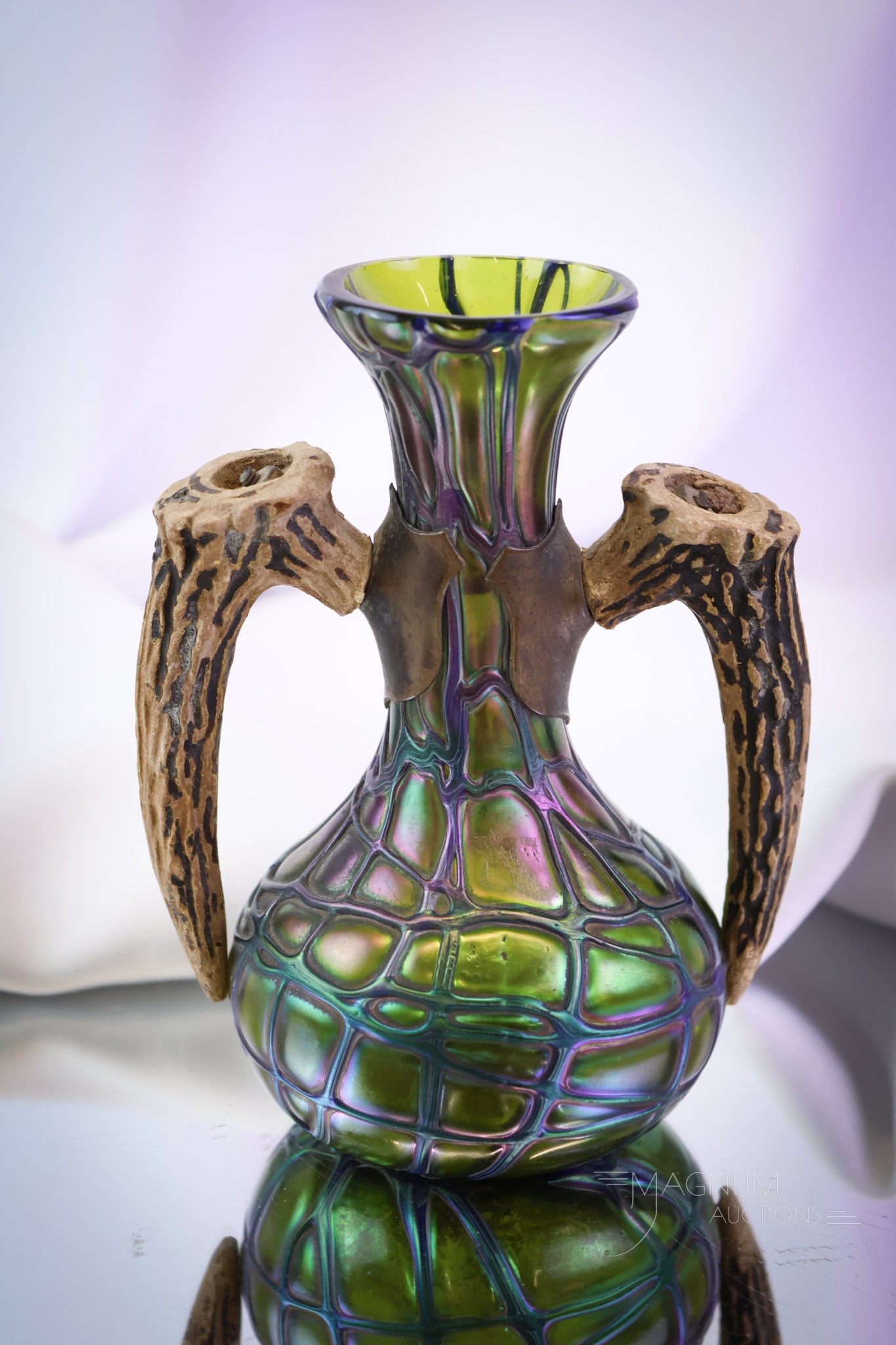 Palme Koenig Green Iridescent Art Glass Stag Horn Handled Vase: A wonderful piece of Palme Koenig. This is a double stag horn handle vase. It measures 6" tall and 4 3/4" wide. The vase has a pronounced, veiny abstract design and great iridescence. SHIPPING NOTICE: